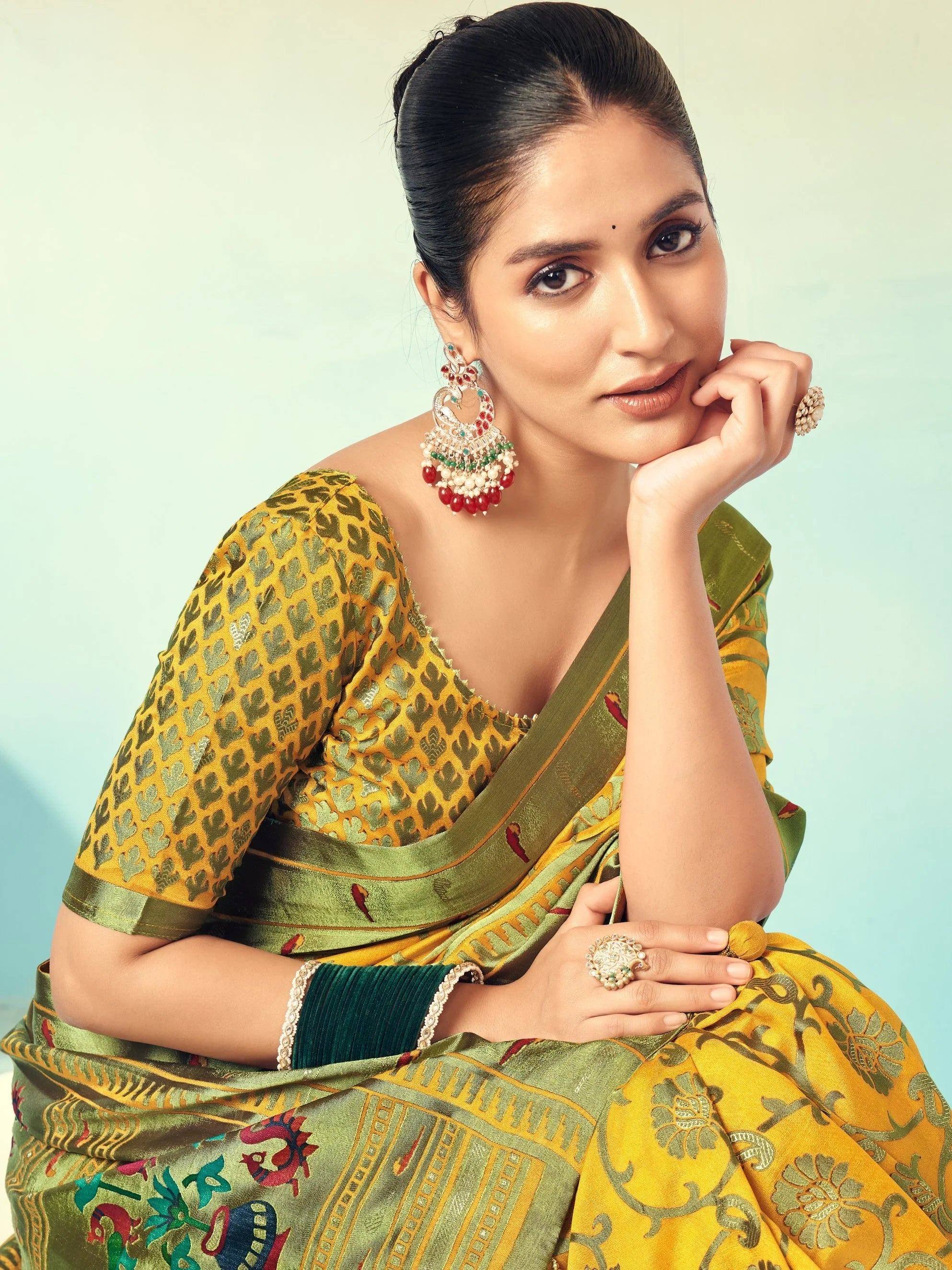 Woman in yellow and green printed saree with ethnic jewelry, showcasing Indian ethnic wear