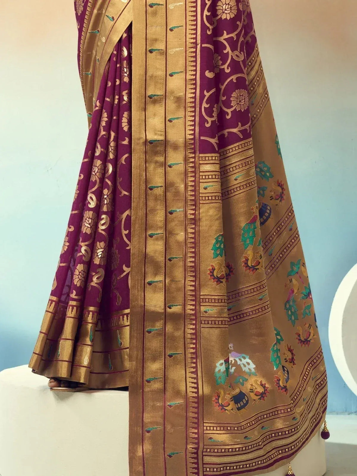 Purple and gold designer saree with floral and peacock motifs, perfect for ethnic wear occasions