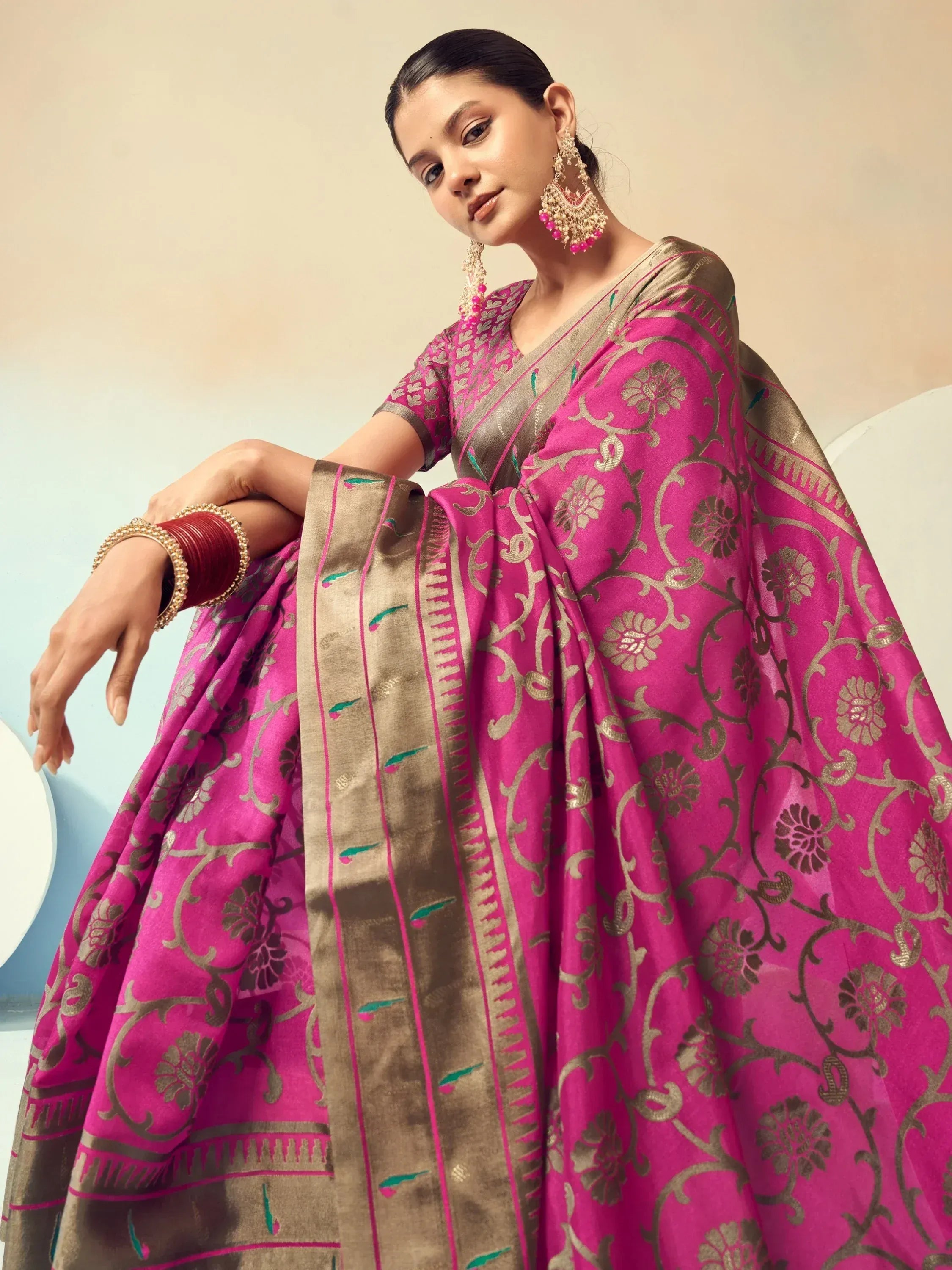Pink and gold floral printed ethnic saree with matching blouse and traditional jewelry