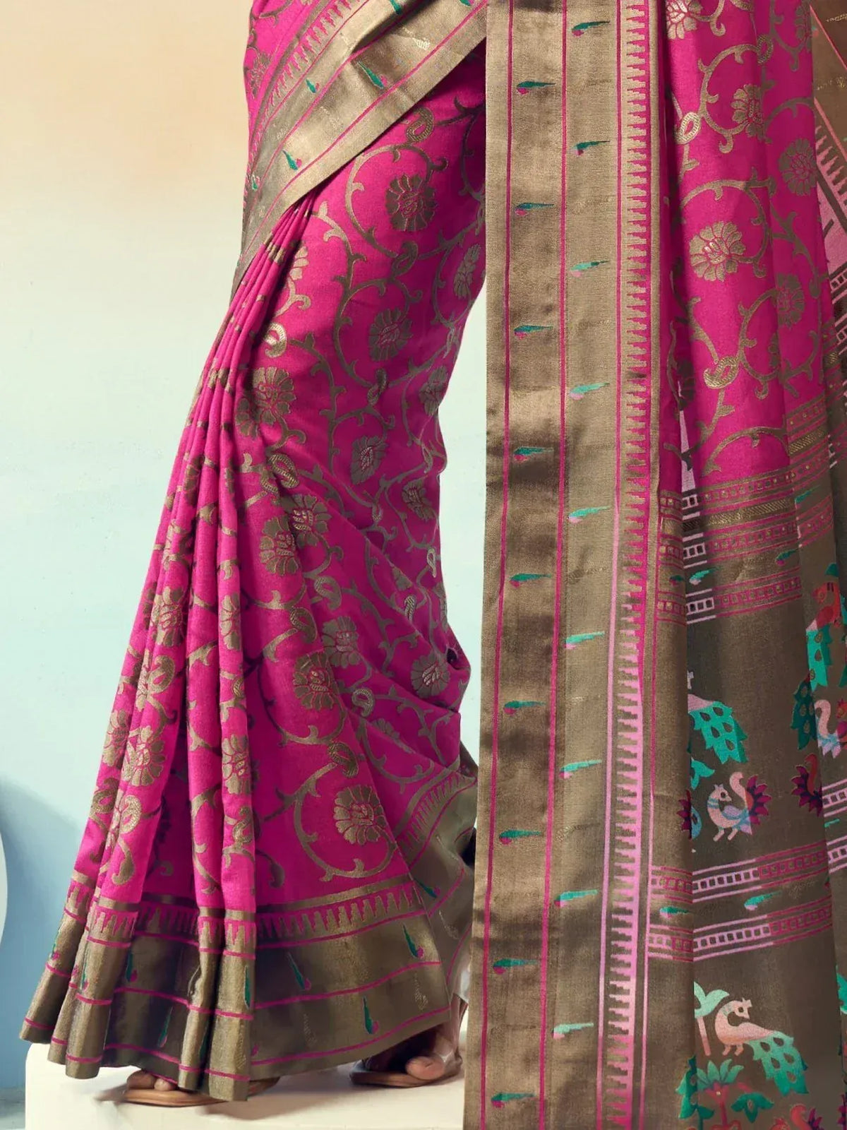 Pink and gold floral printed saree with peacock motifs and woven border, ideal for Indian ethnic wear