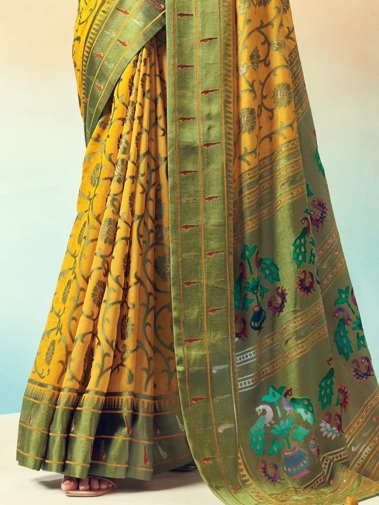Yellow and green ethnic saree with floral and peacock motifs, perfect for Indian occasions