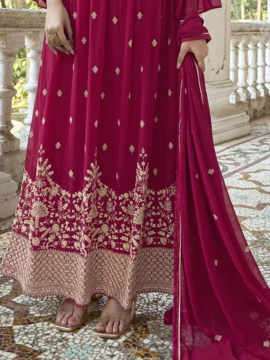 Maroon ethnic gown with gold floral embroidery, perfect for Indian occasions and weddings.
