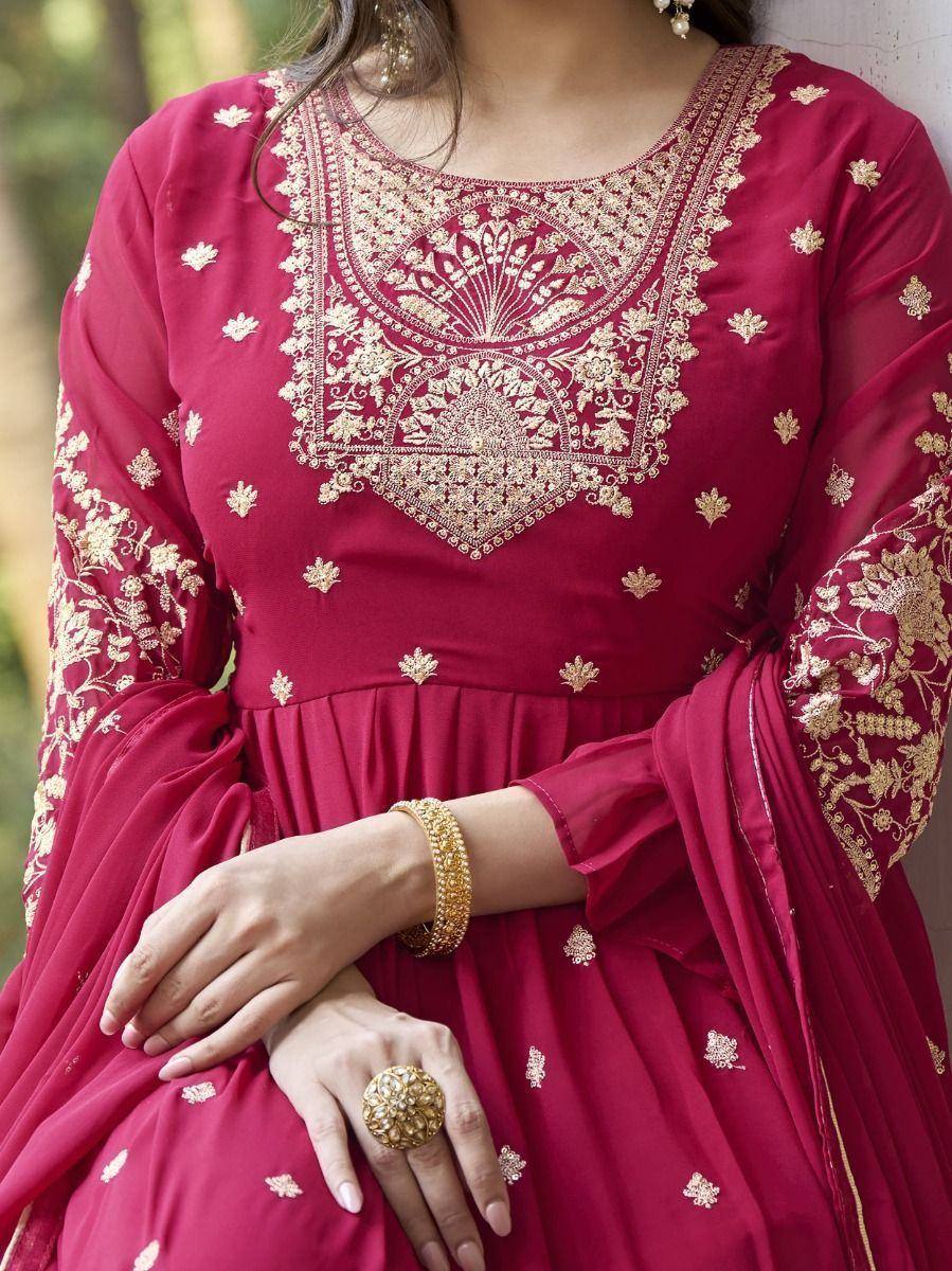 Maroon ethnic gown with gold embroidery, perfect for Indian occasions and festive wear.