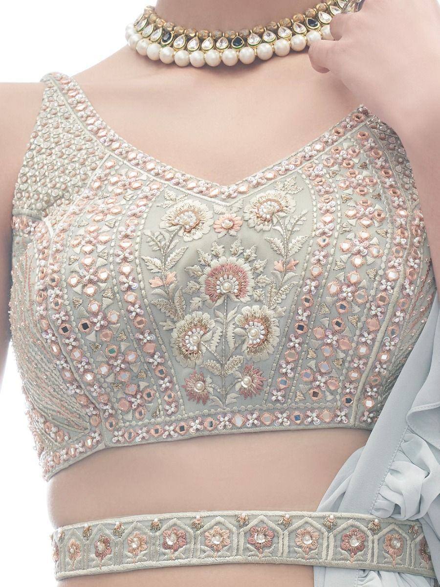 Embroidered floral lehenga choli blouse with pearl and mirror work, paired with matching waistband and choker necklace