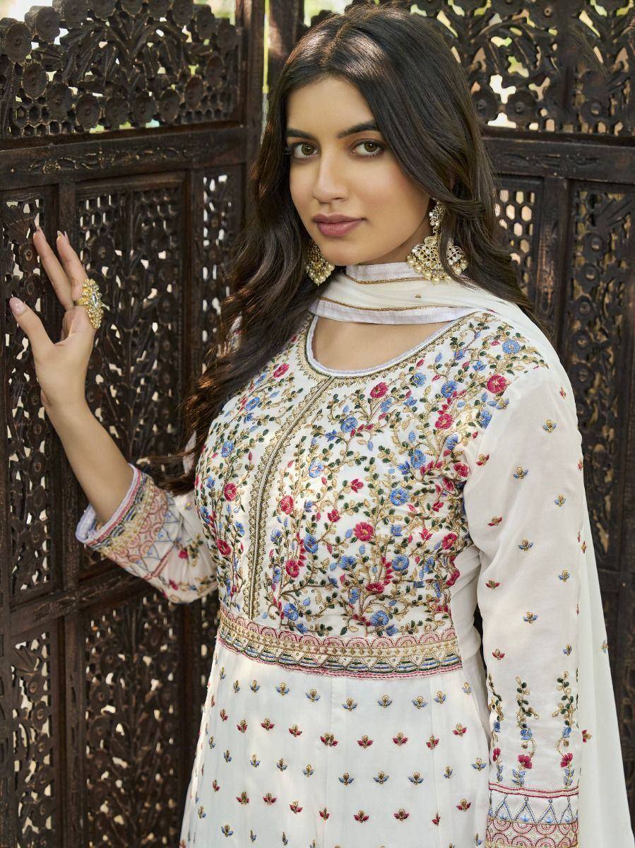 White floral embroidered ethnic kurta with choker neckline, paired with statement jewelry, perfect for Indian occasions.