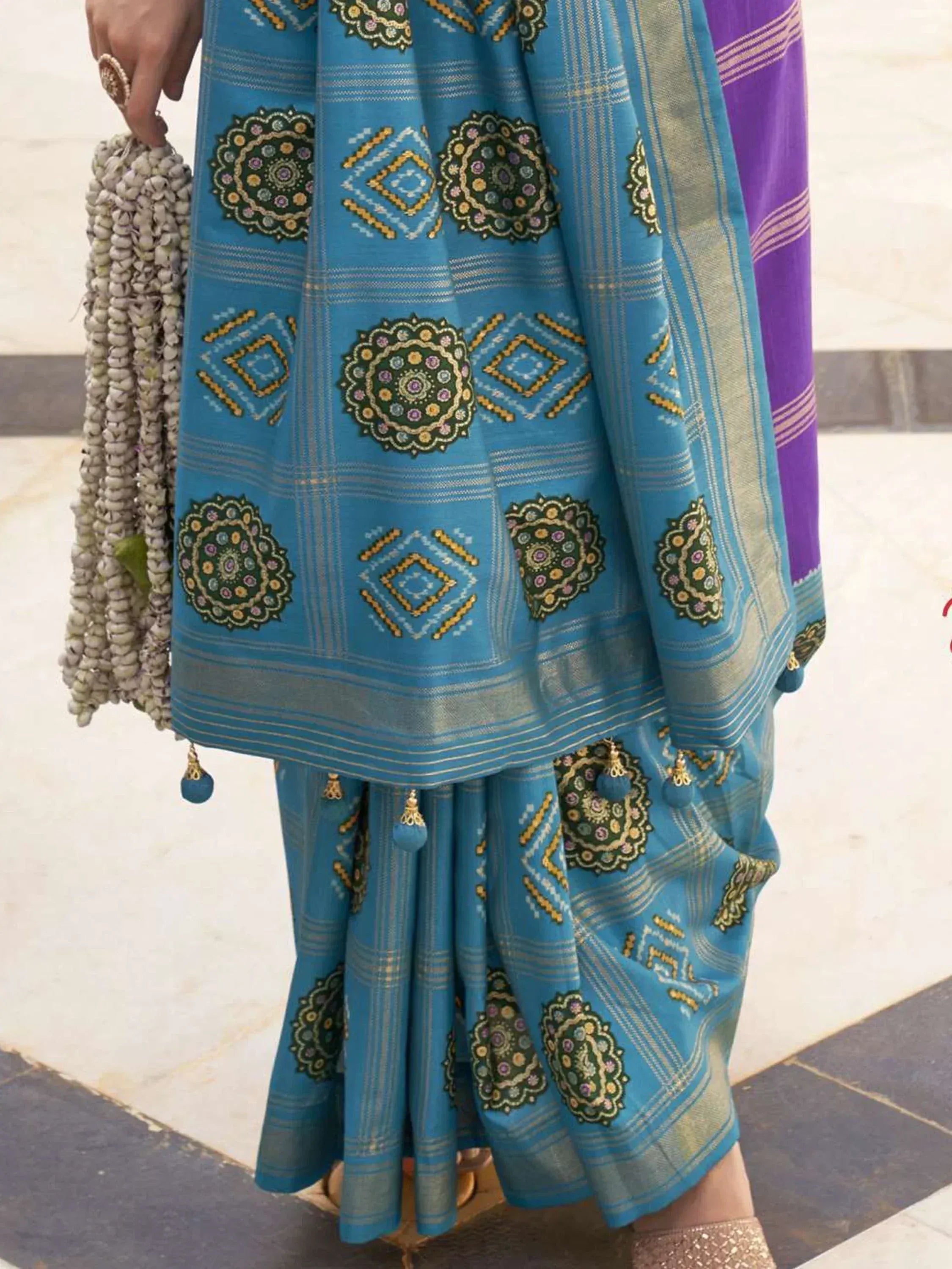 Blue embroidered ethnic saree with floral motifs and gold border, paired with matching palazzo pants