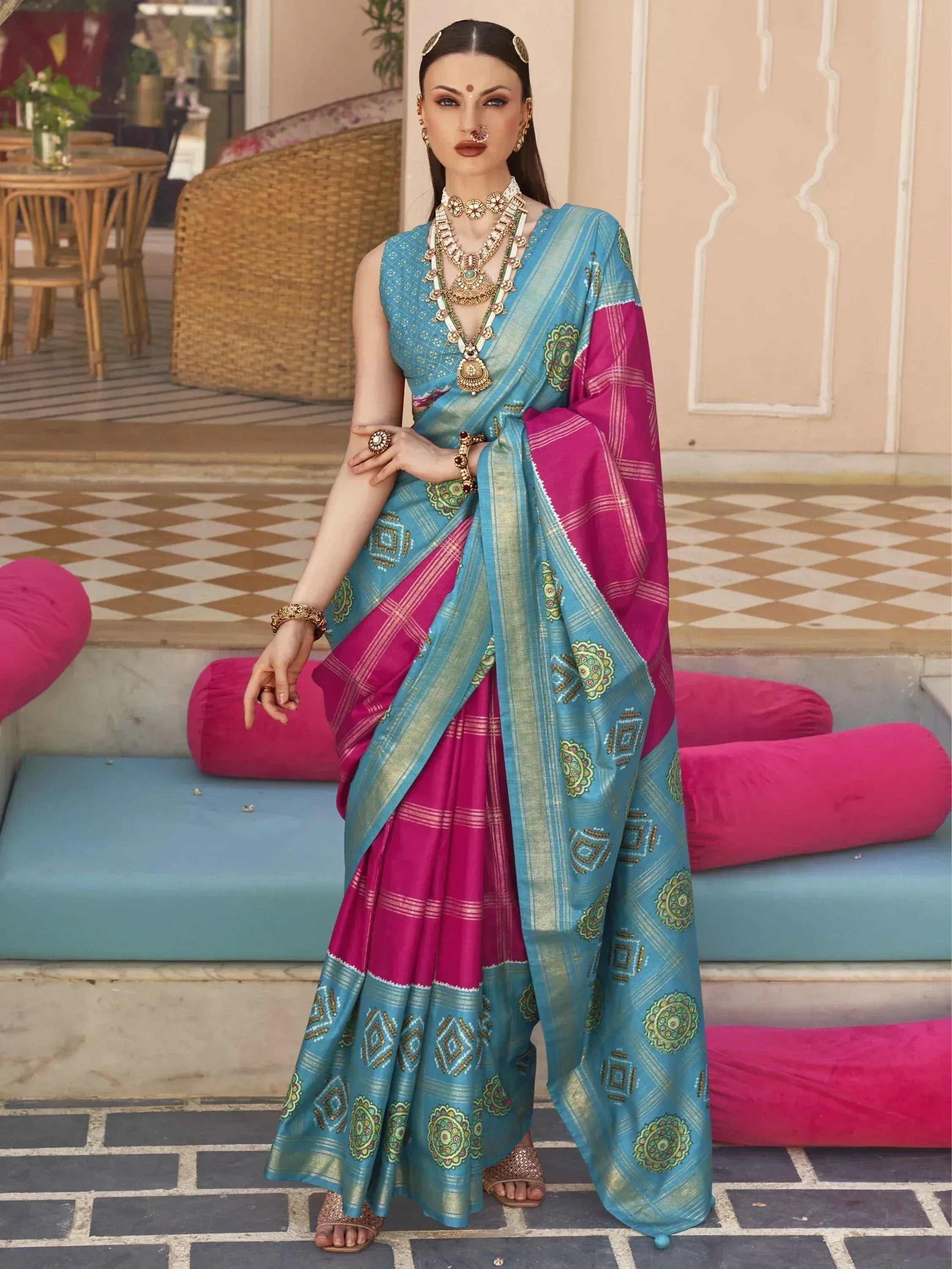 Blue and pink ethnic saree with gold embroidery, styled with traditional jewelry for Indian occasions