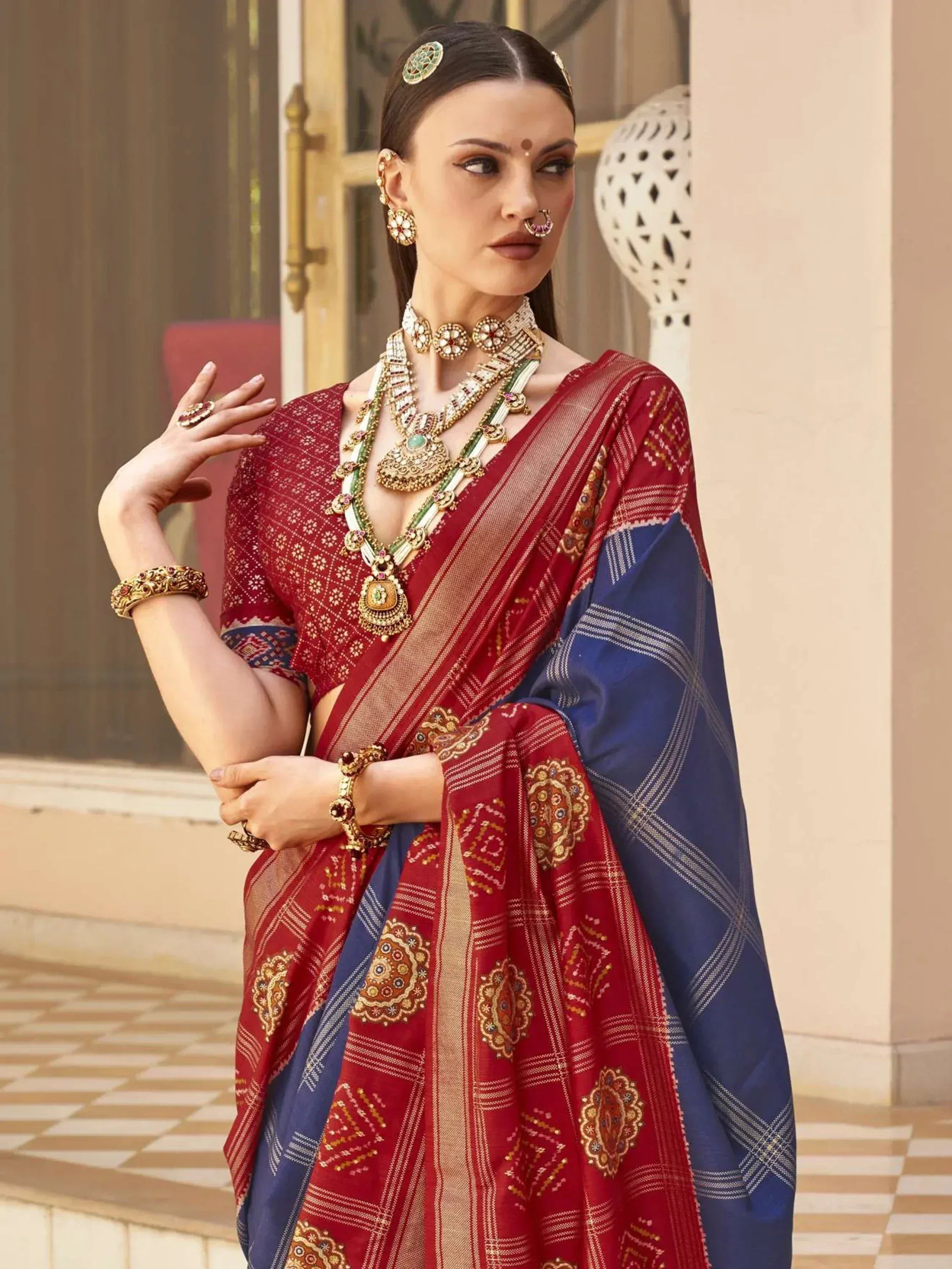 Red and blue embroidered saree with gold jewelry, traditional Indian ethnic wear