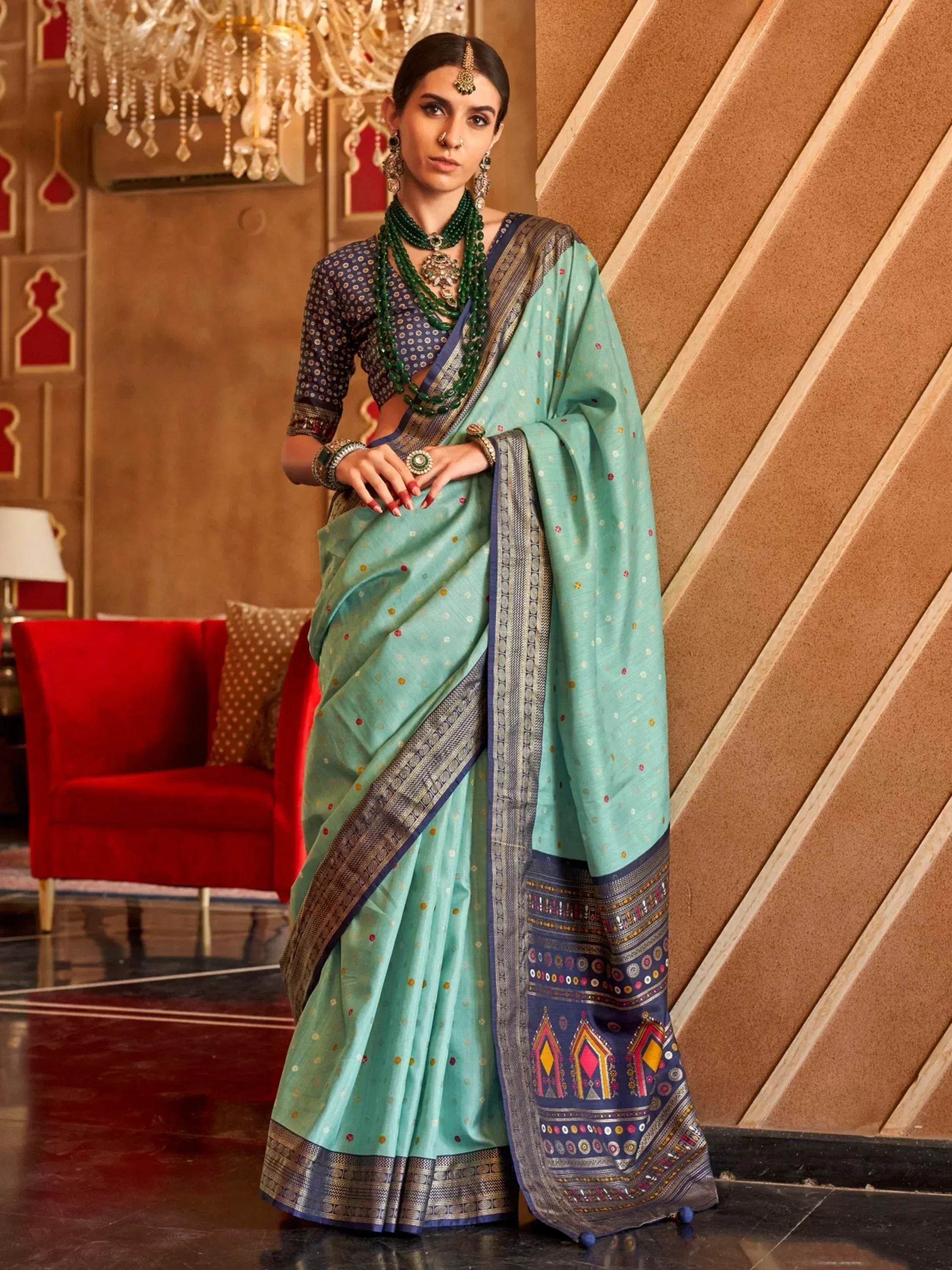 Elegant mint green saree with intricate border, paired with patterned blouse and traditional jewelry for Indian ethnic wear