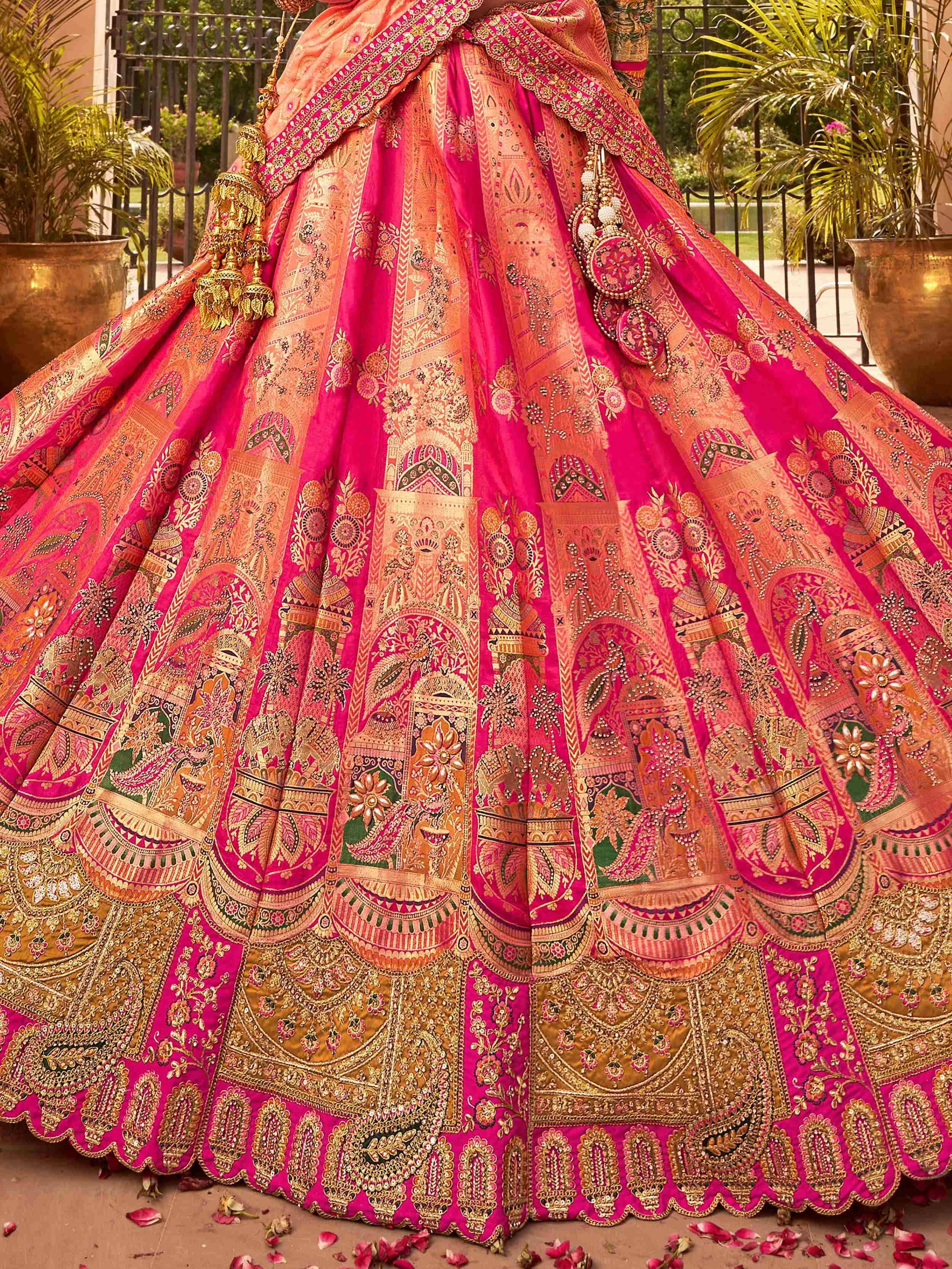 Pink and gold embroidered lehenga choli with intricate patterns, perfect for Indian weddings and festive occasions.