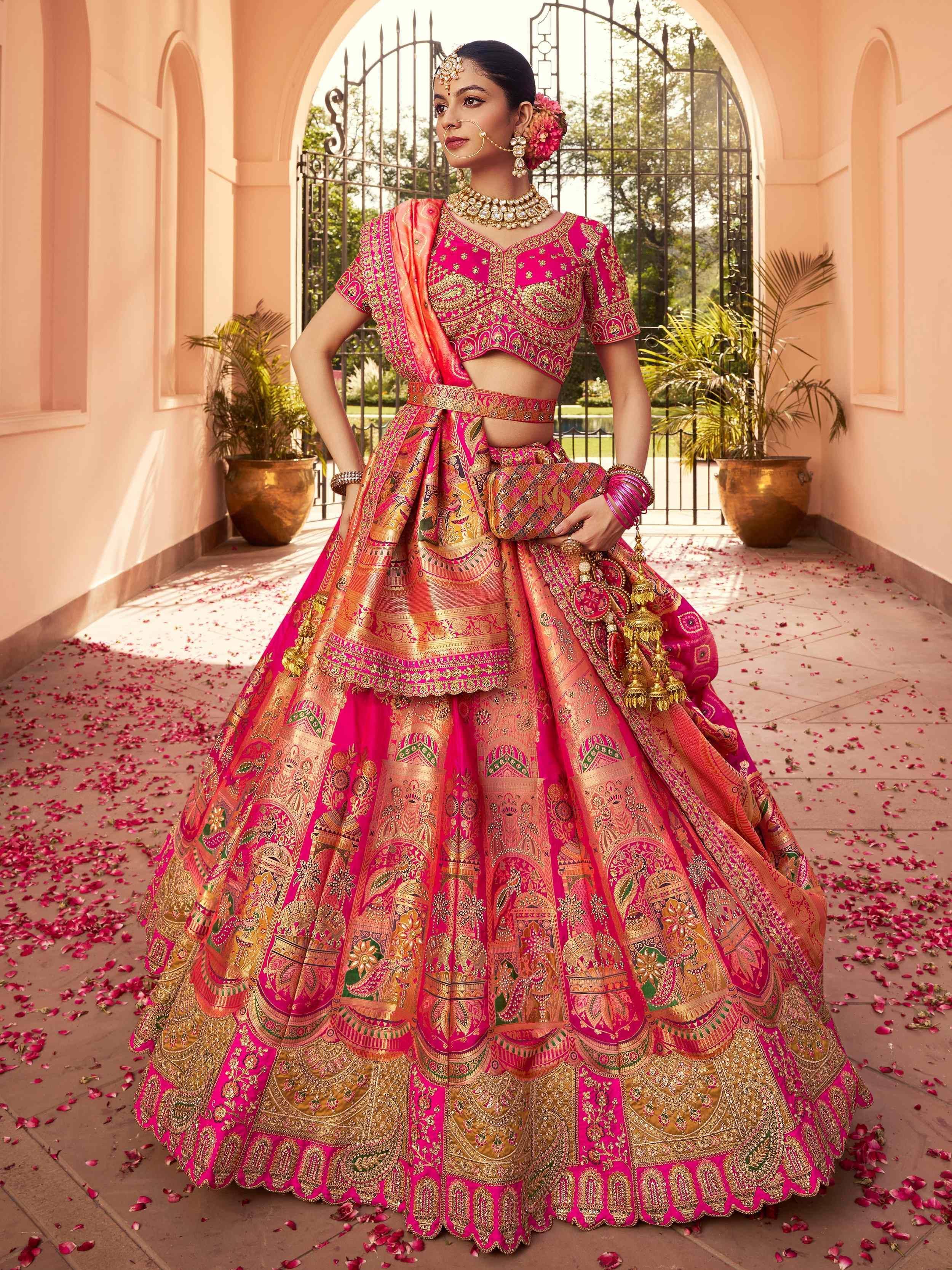 Pink and gold designer lehenga choli with intricate embroidery, perfect for Indian weddings and festive occasions.