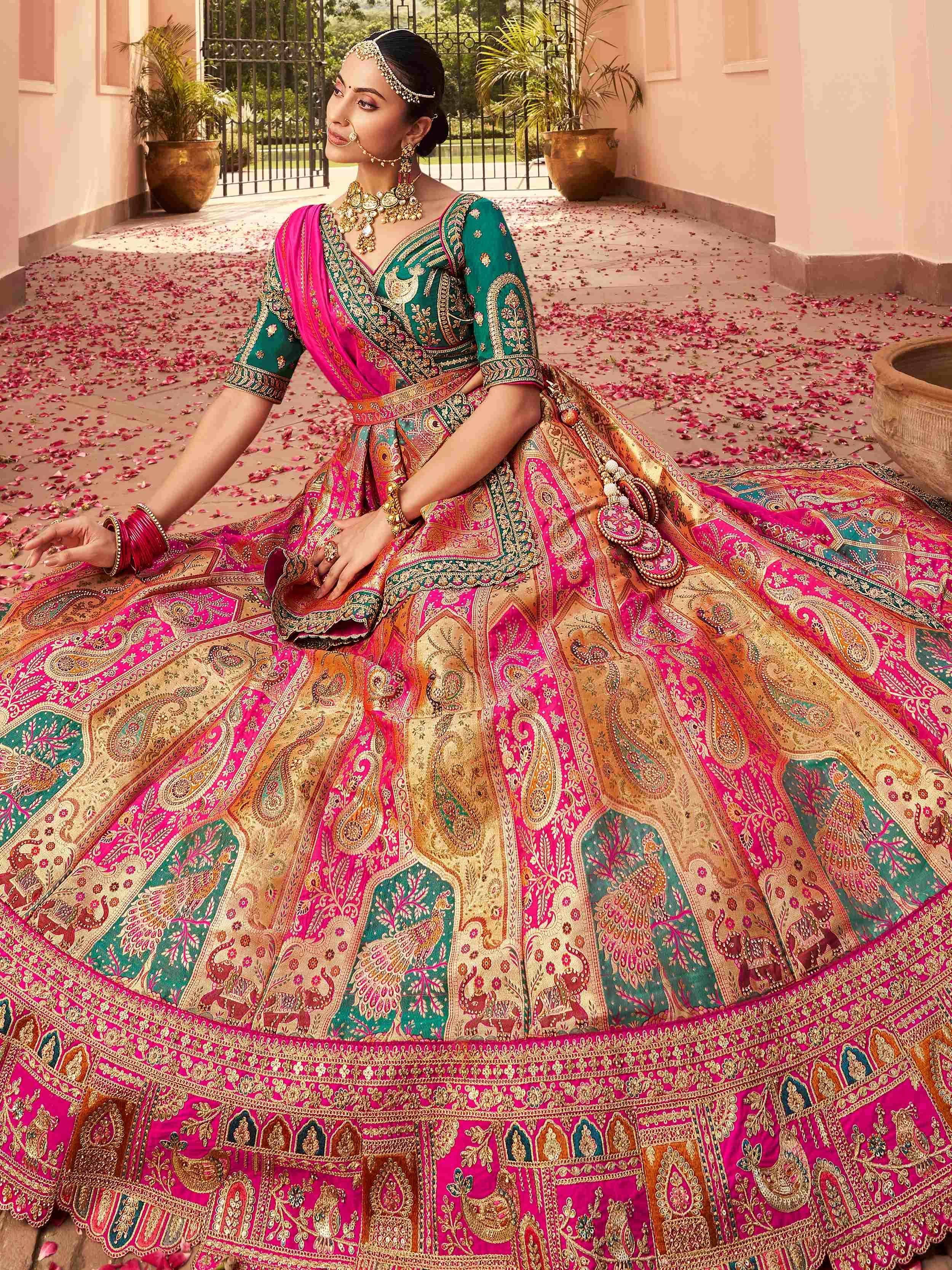 Elegant pink and green designer lehenga choli with intricate embroidery, perfect for Indian weddings and festive occasions.