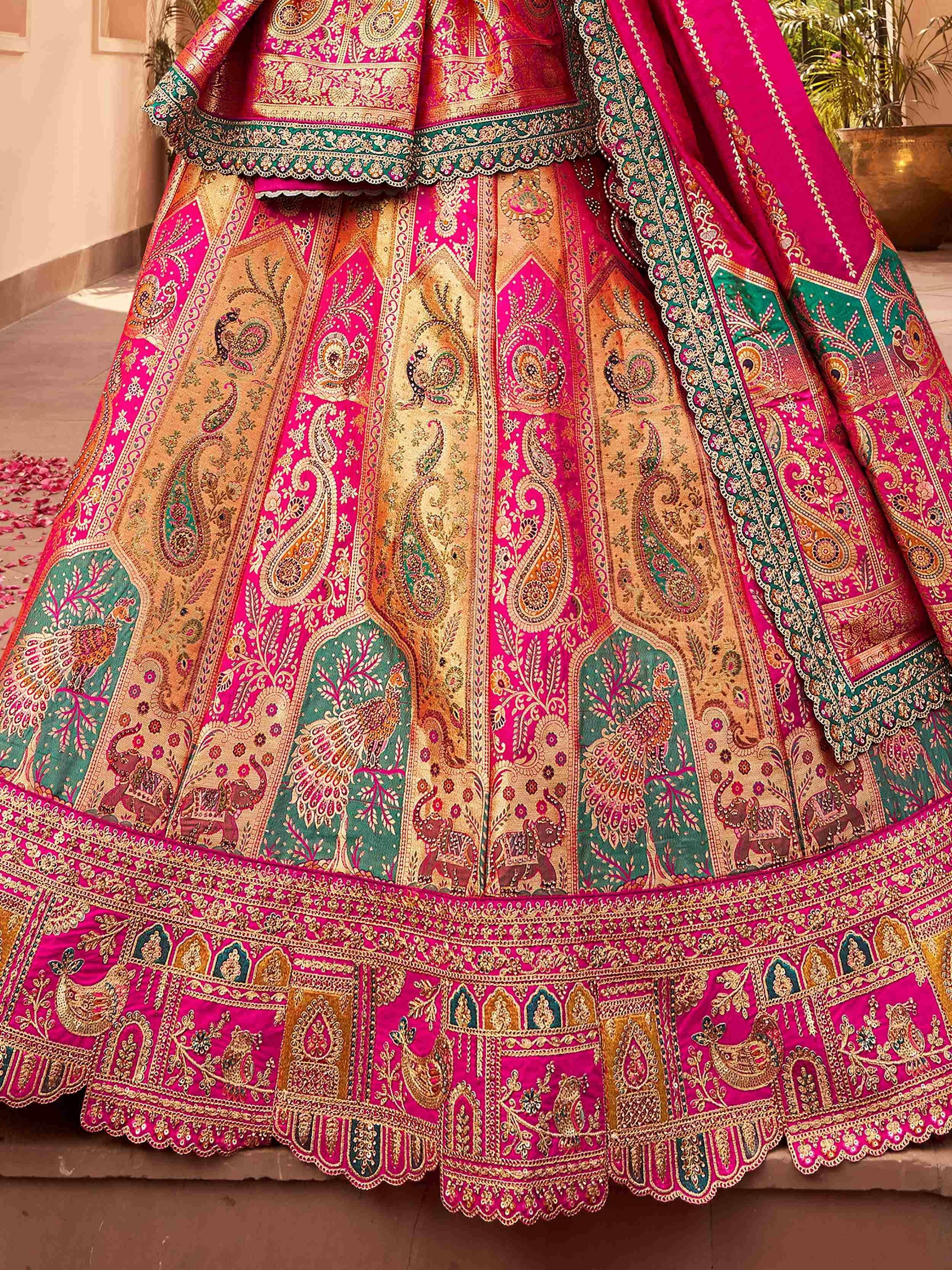 Pink and gold embroidered lehenga choli with peacock and elephant motifs, perfect for Indian weddings