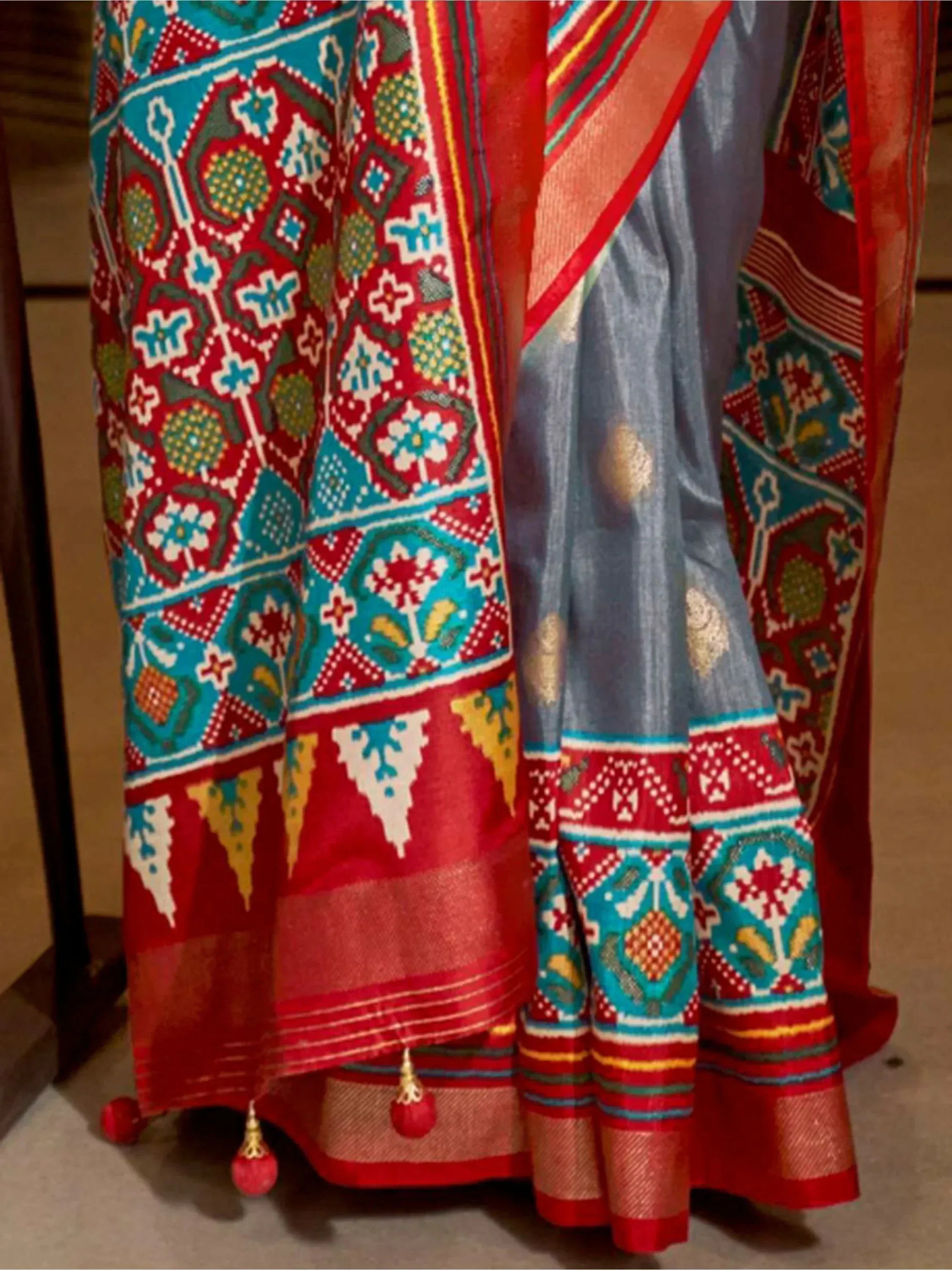 Grey and red ethnic saree with vibrant geometric and floral print, perfect for Indian occasions