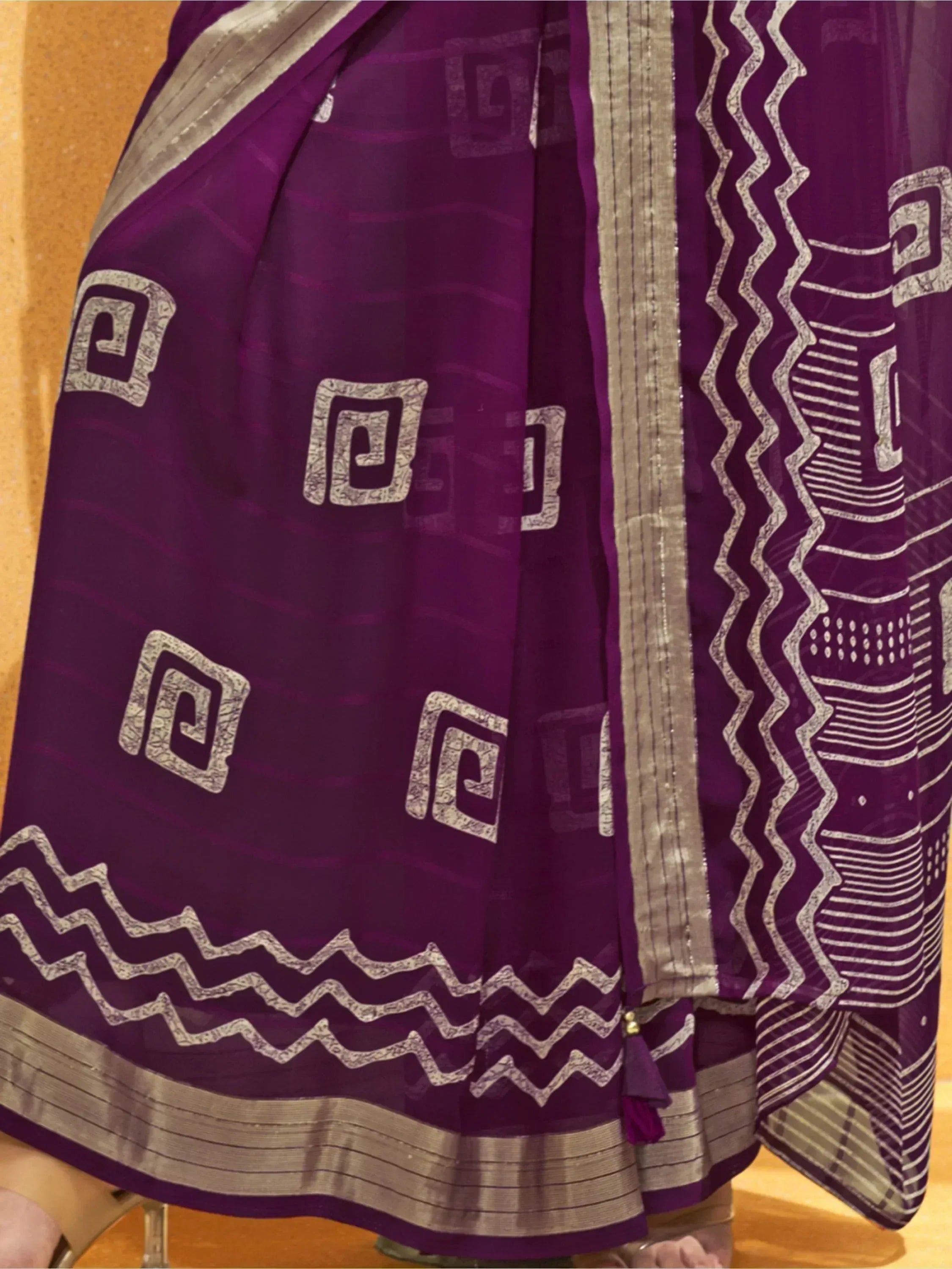 Purple ethnic saree with silver geometric print and woven border, ideal for Indian occasions