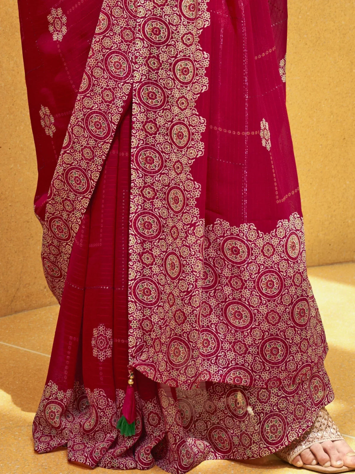 Red ethnic saree with intricate gold and green floral patterns, perfect for Indian weddings and festivals