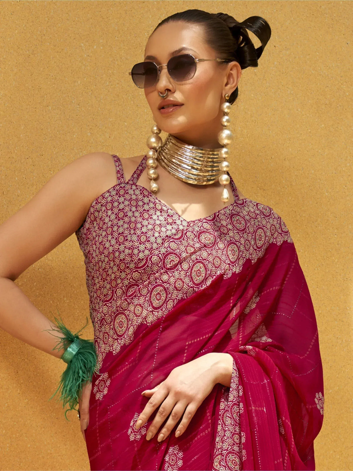 Stylish maroon saree with floral print, gold jewelry, and sunglasses for ethnic wear