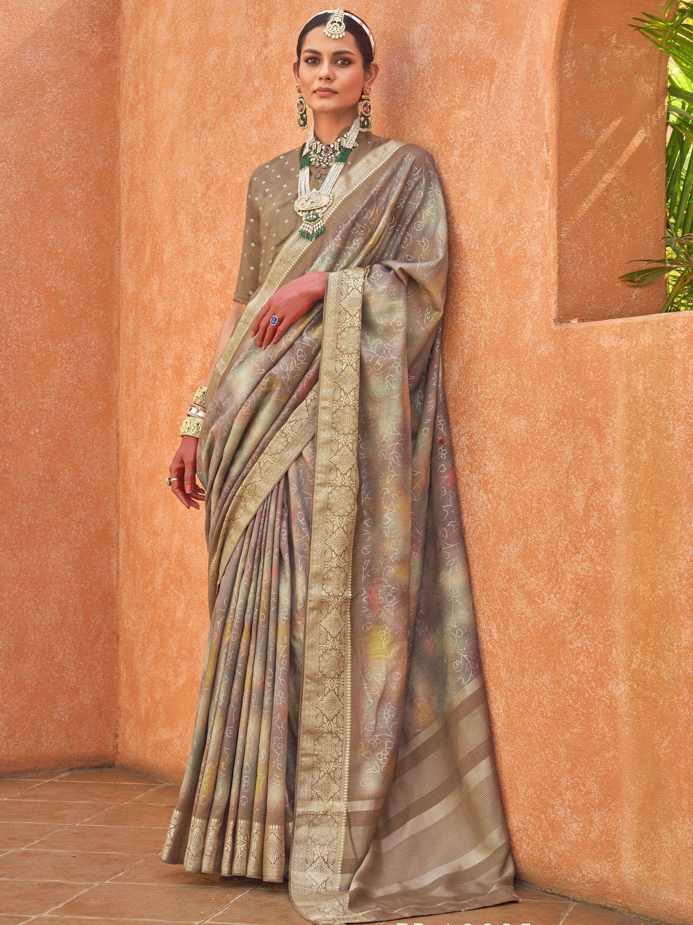 Elegant Indian saree with gold embroidery and traditional jewelry, perfect for ethnic wear occasions.