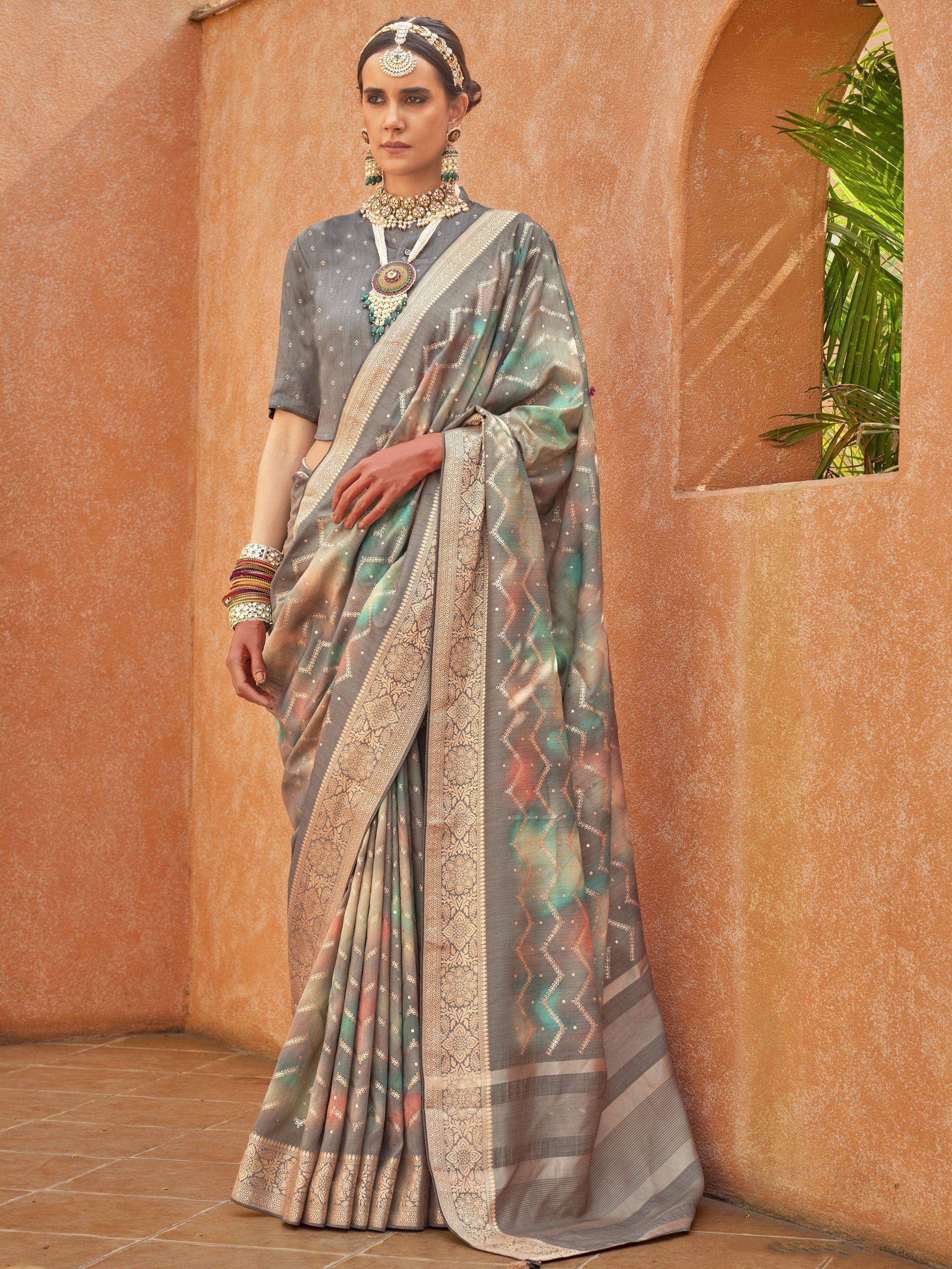 Elegant grey saree with gold zari and pastel accents, paired with traditional Indian jewelry for festive occasions.