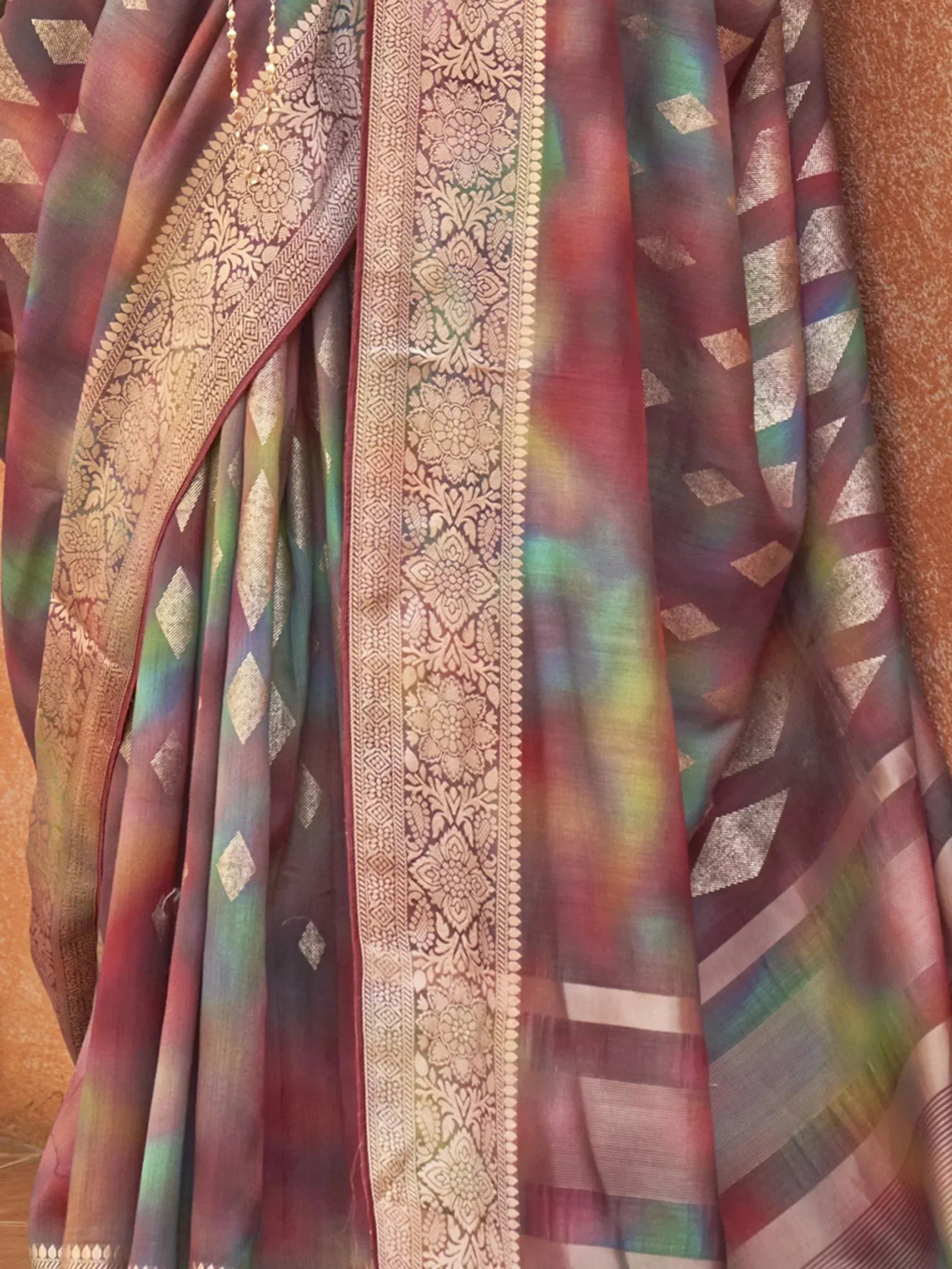 Multicolor designer saree with gold floral border and geometric patterns, ideal for ethnic wear