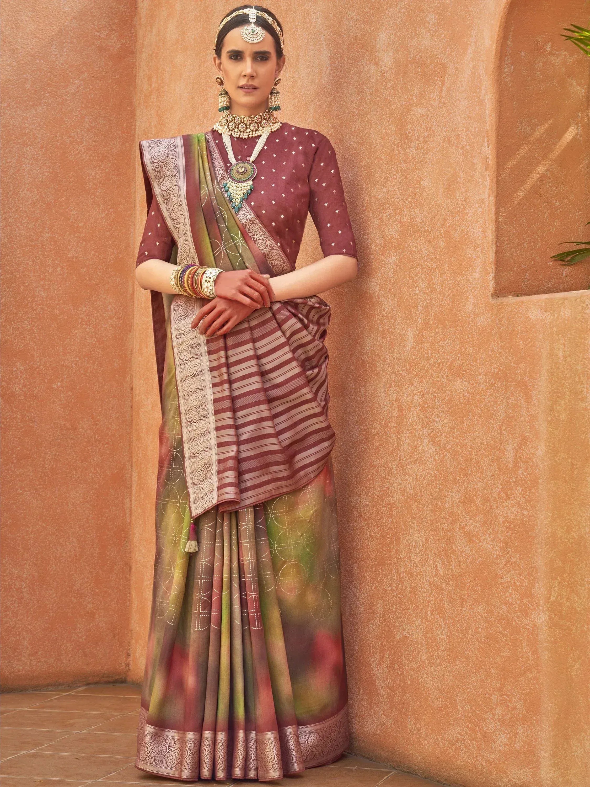 Woman in maroon and green designer saree with embroidery, traditional Indian ethnic wear