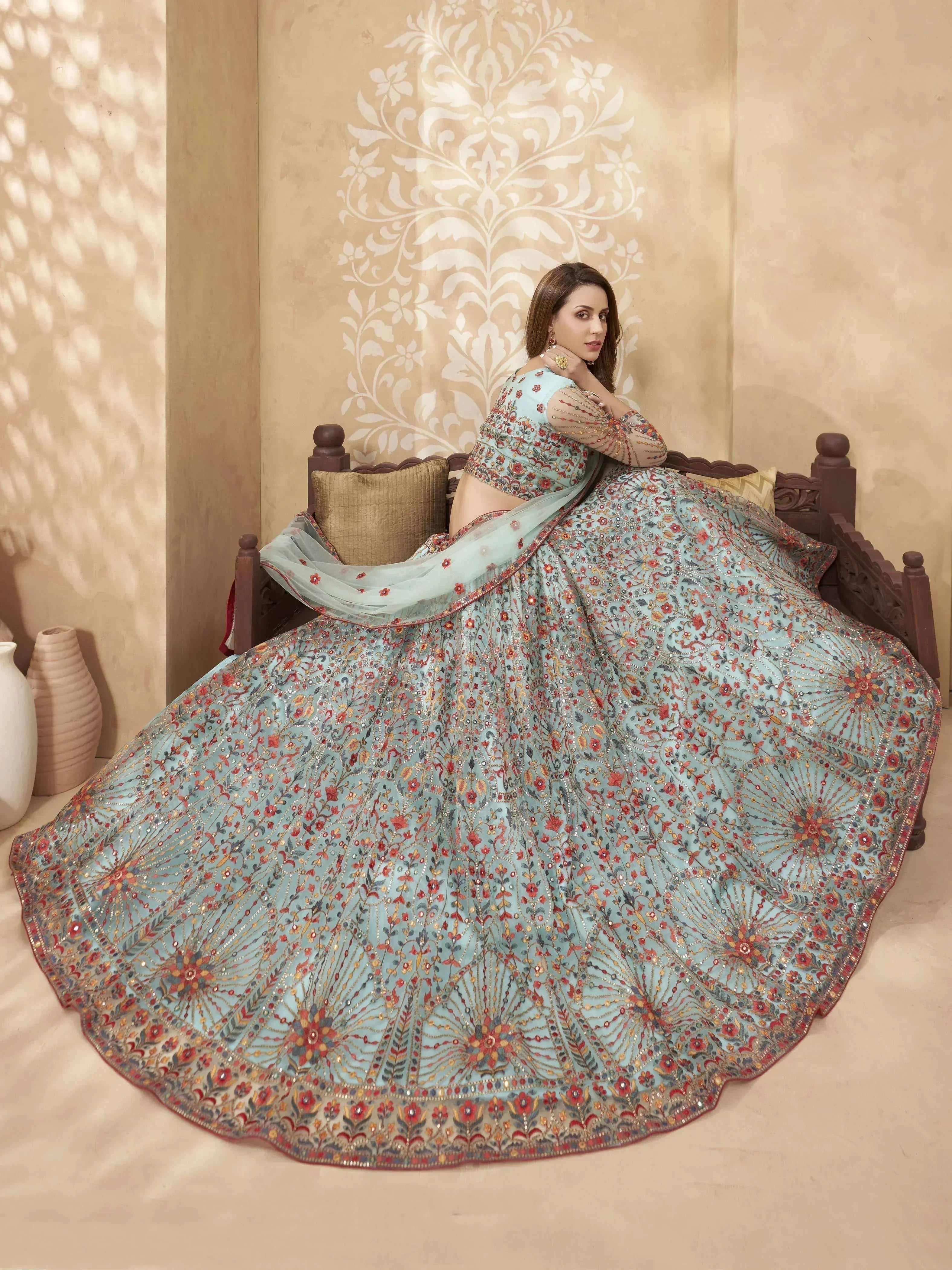 Elegant light blue lehenga choli with intricate floral embroidery and mirror work, perfect for Indian weddings and festive occasions.