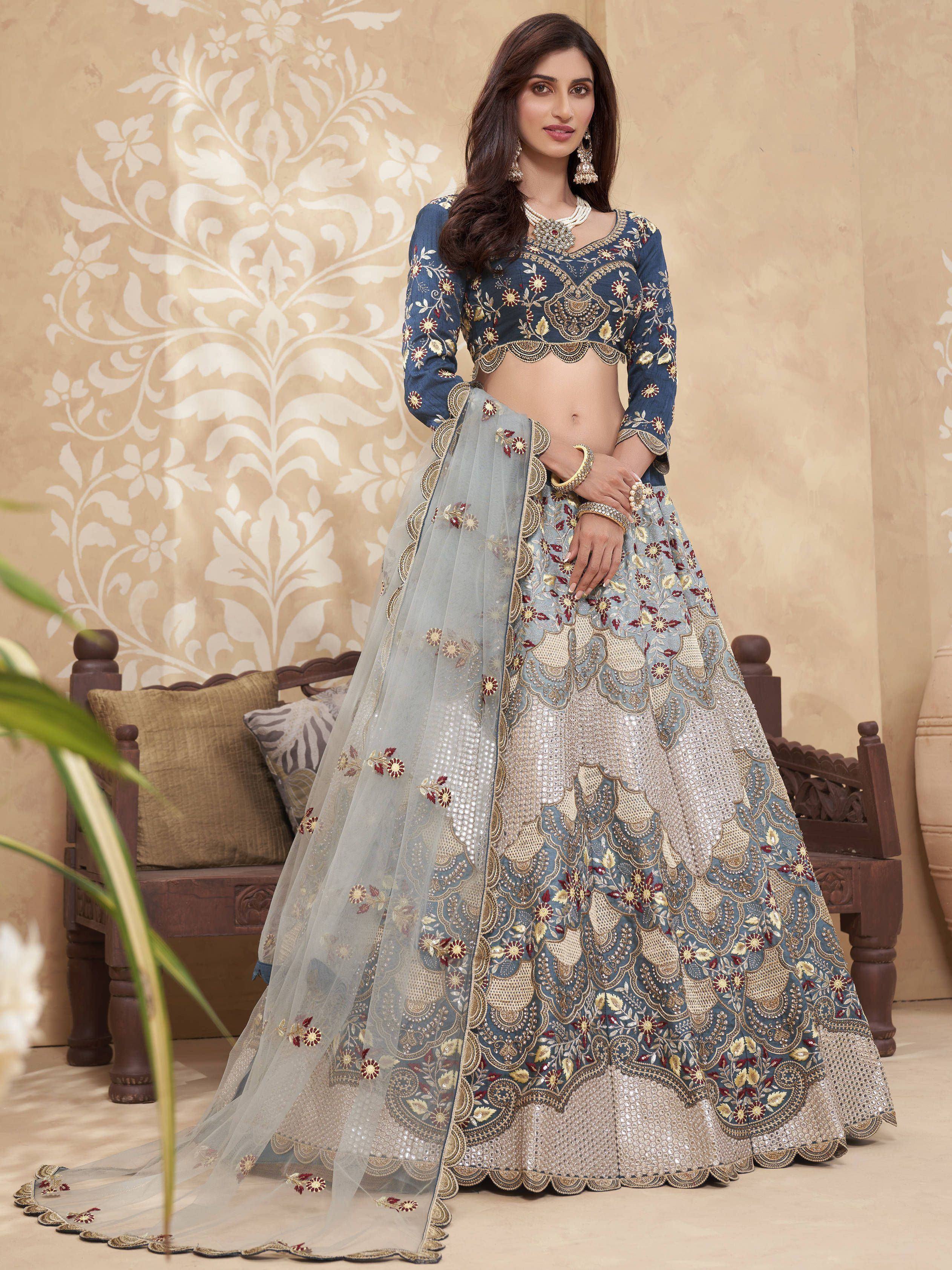 Blue embroidered lehenga choli with gold and maroon floral detailing, perfect for Indian weddings and festive occasions.