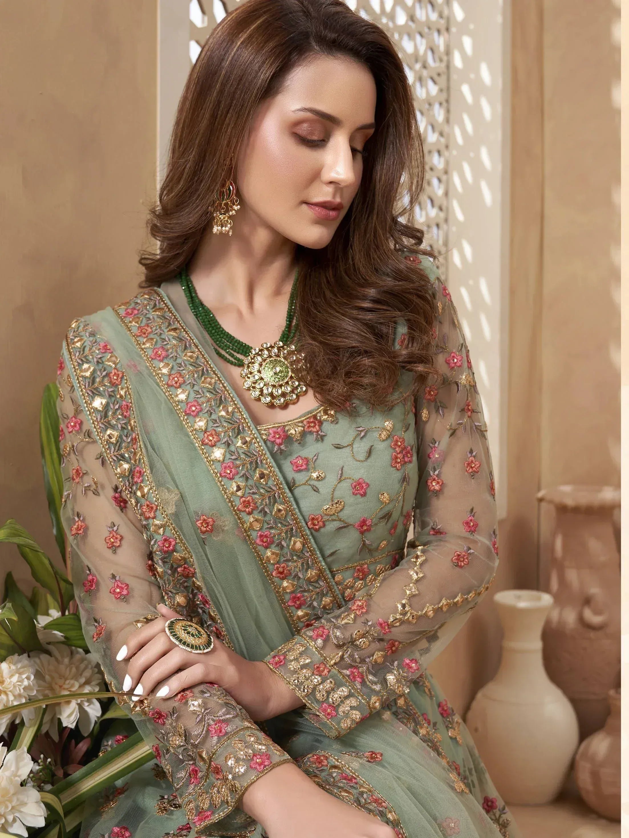 Elegant green embroidered salwar kameez with floral design and sheer sleeves, perfect for Indian ethnic wear.