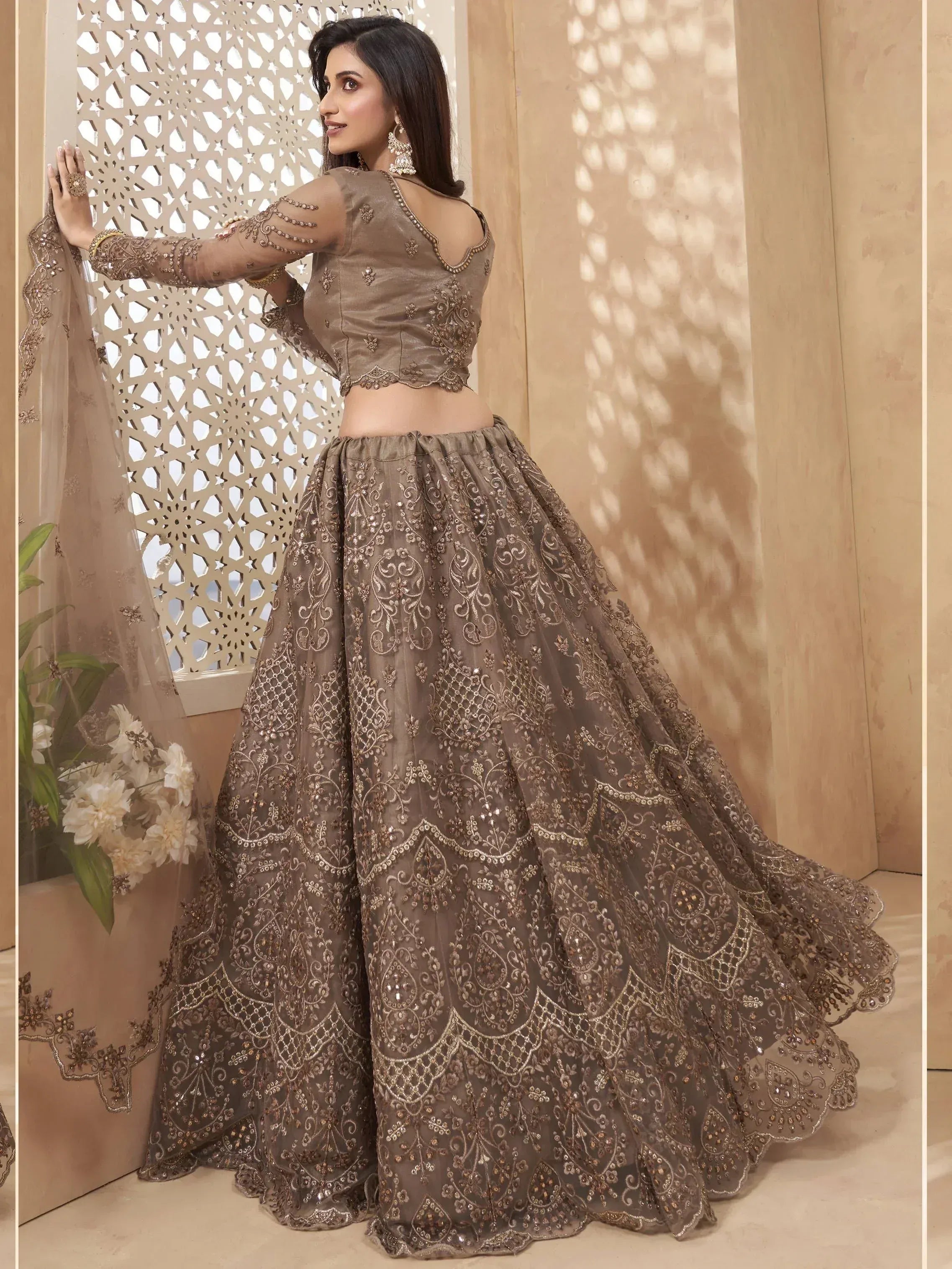 Elegant brown embroidered lehenga choli with sheer sleeves and dupatta, perfect for Indian weddings and festive occasions.