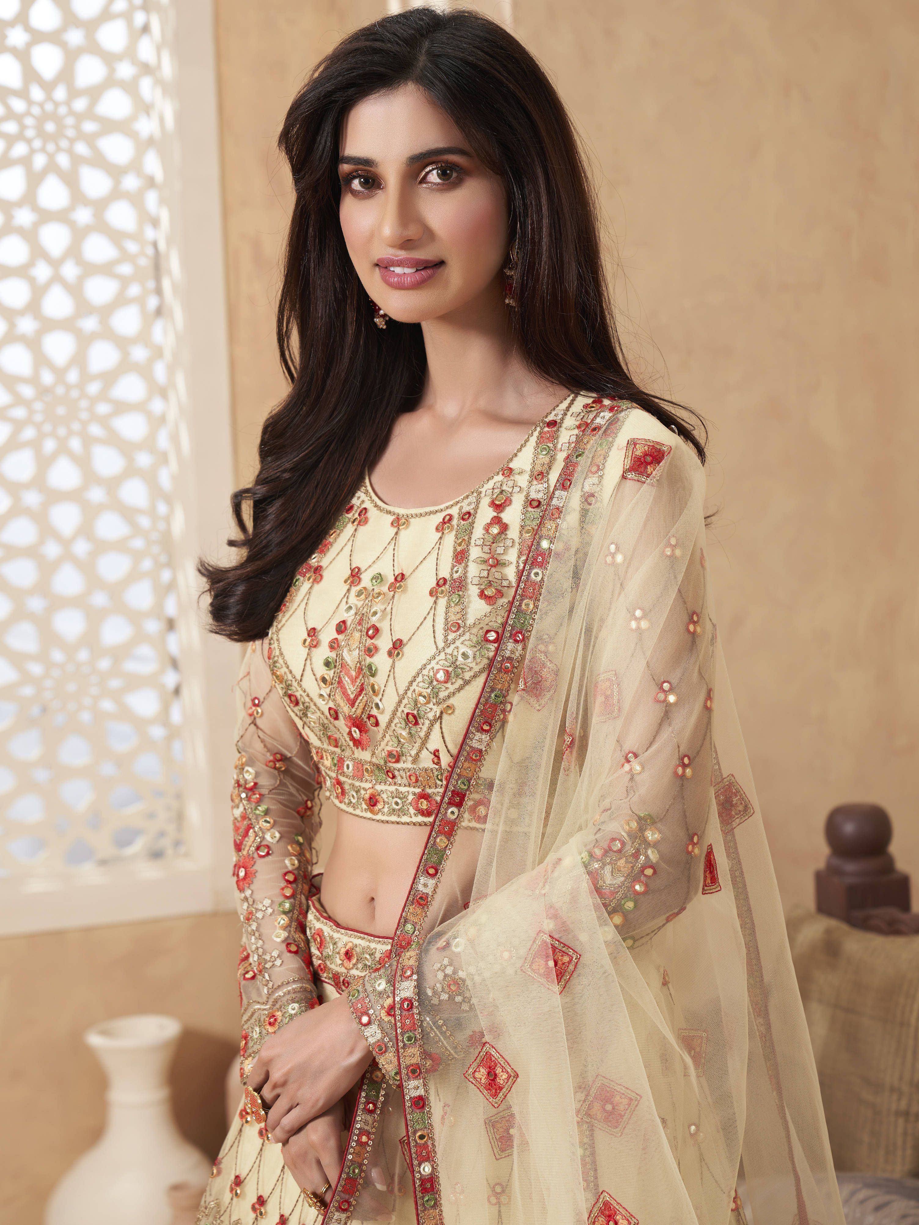 Cream embroidered Indian ethnic wear with mirror work and sheer dupatta, perfect for festive occasions.
