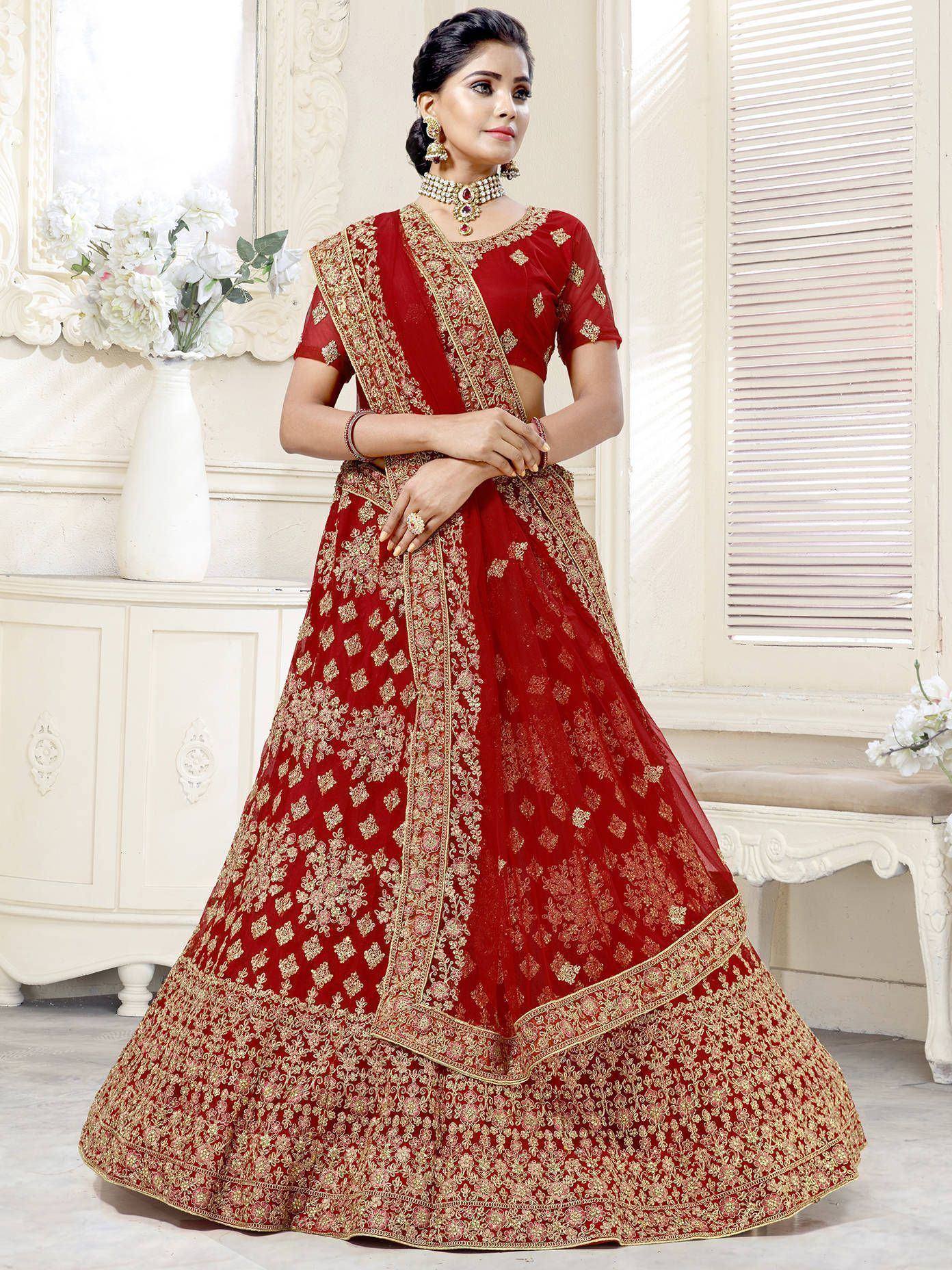 Red and gold embroidered lehenga choli with intricate floral patterns, perfect for Indian weddings and festive occasions.