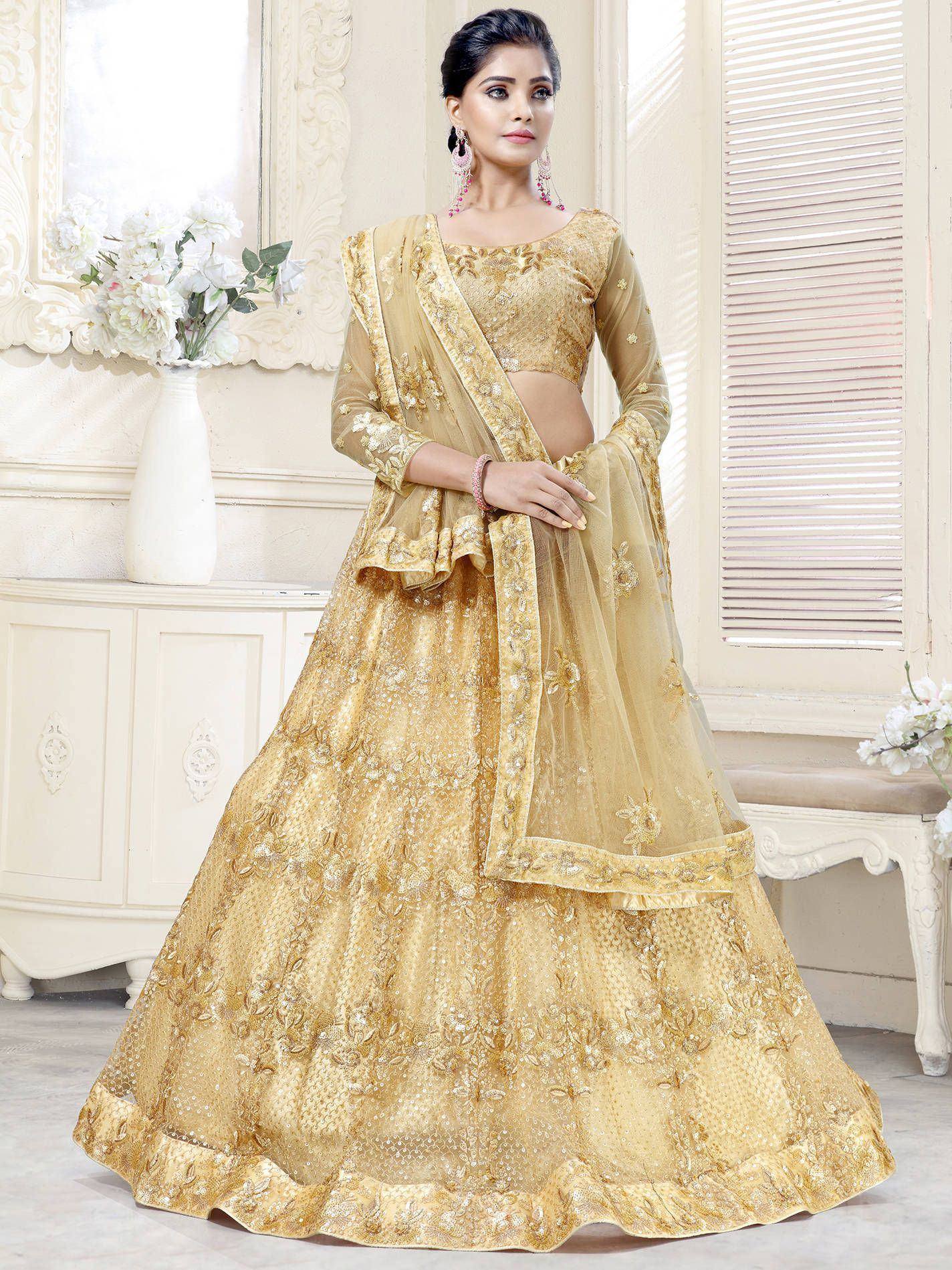 Golden embroidered lehenga choli with sheer dupatta, perfect for Indian weddings and festive occasions