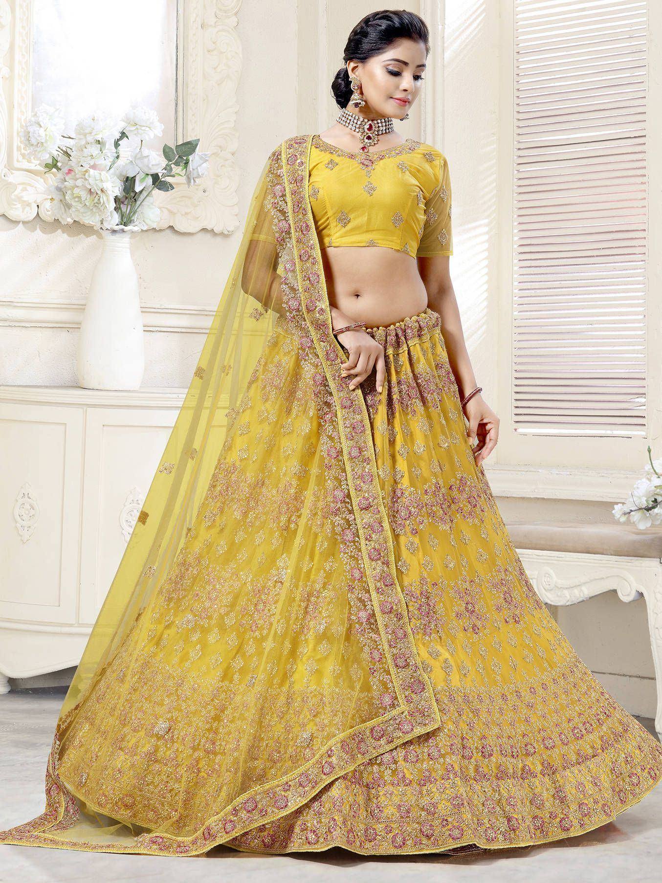 Yellow designer lehenga choli with floral embroidery and sheer dupatta for Indian ethnic wear
