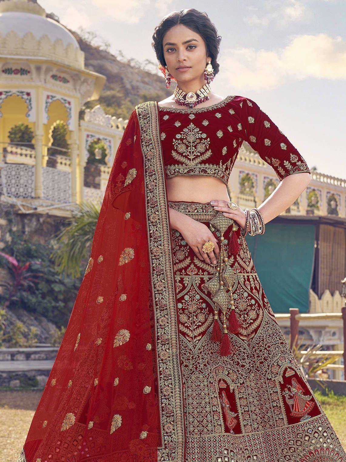 Red embroidered lehenga choli with gold detailing, perfect for Indian weddings and festive occasions
