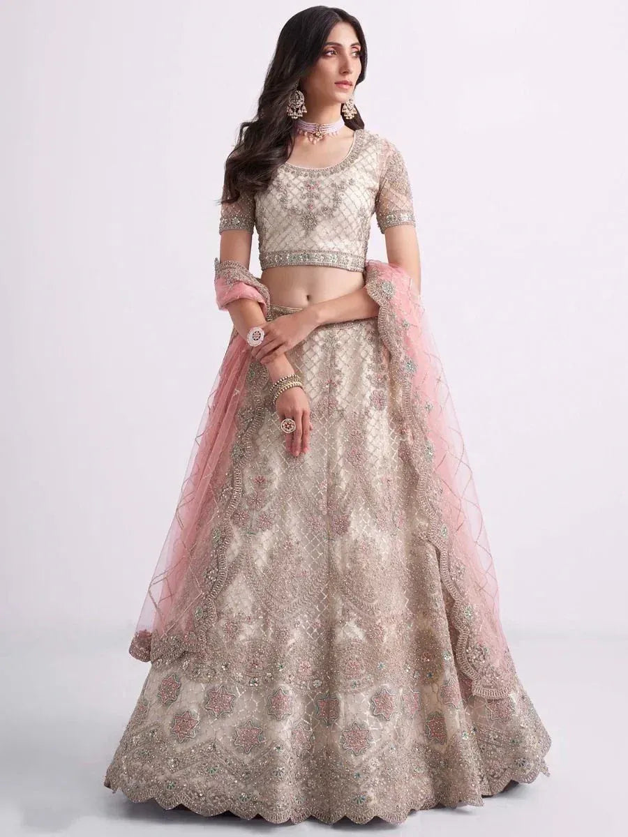 Elegant beige embroidered lehenga choli with pink dupatta, perfect for Indian weddings and festive occasions