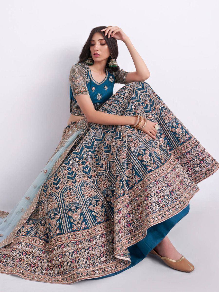 Blue embroidered lehenga choli with intricate gold patterns, perfect for Indian ethnic wear occasions