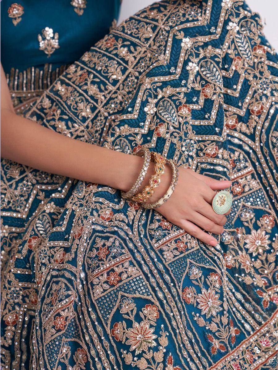 Teal designer lehenga choli with gold floral embroidery and traditional bangles