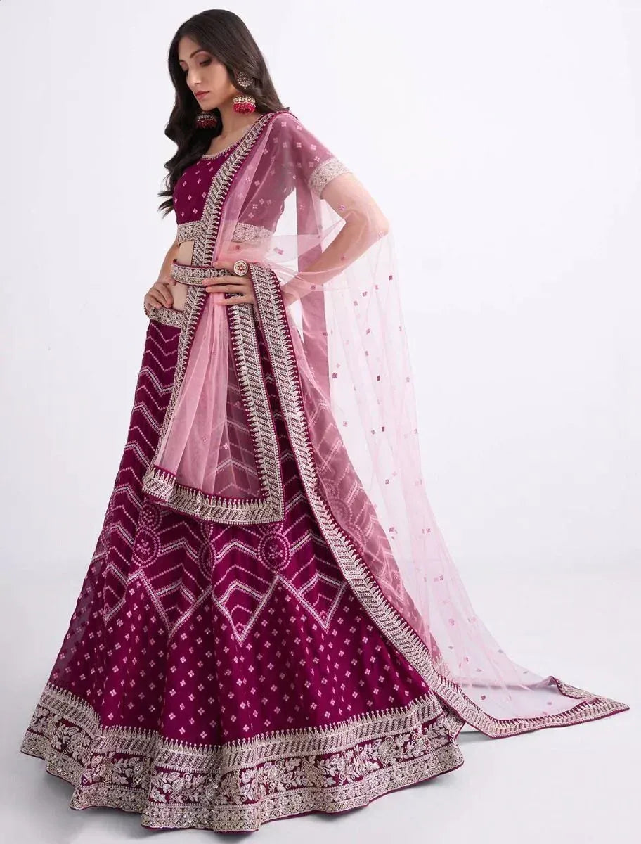 Maroon designer lehenga choli with intricate embroidery and sheer dupatta, perfect for Indian ethnic occasions.