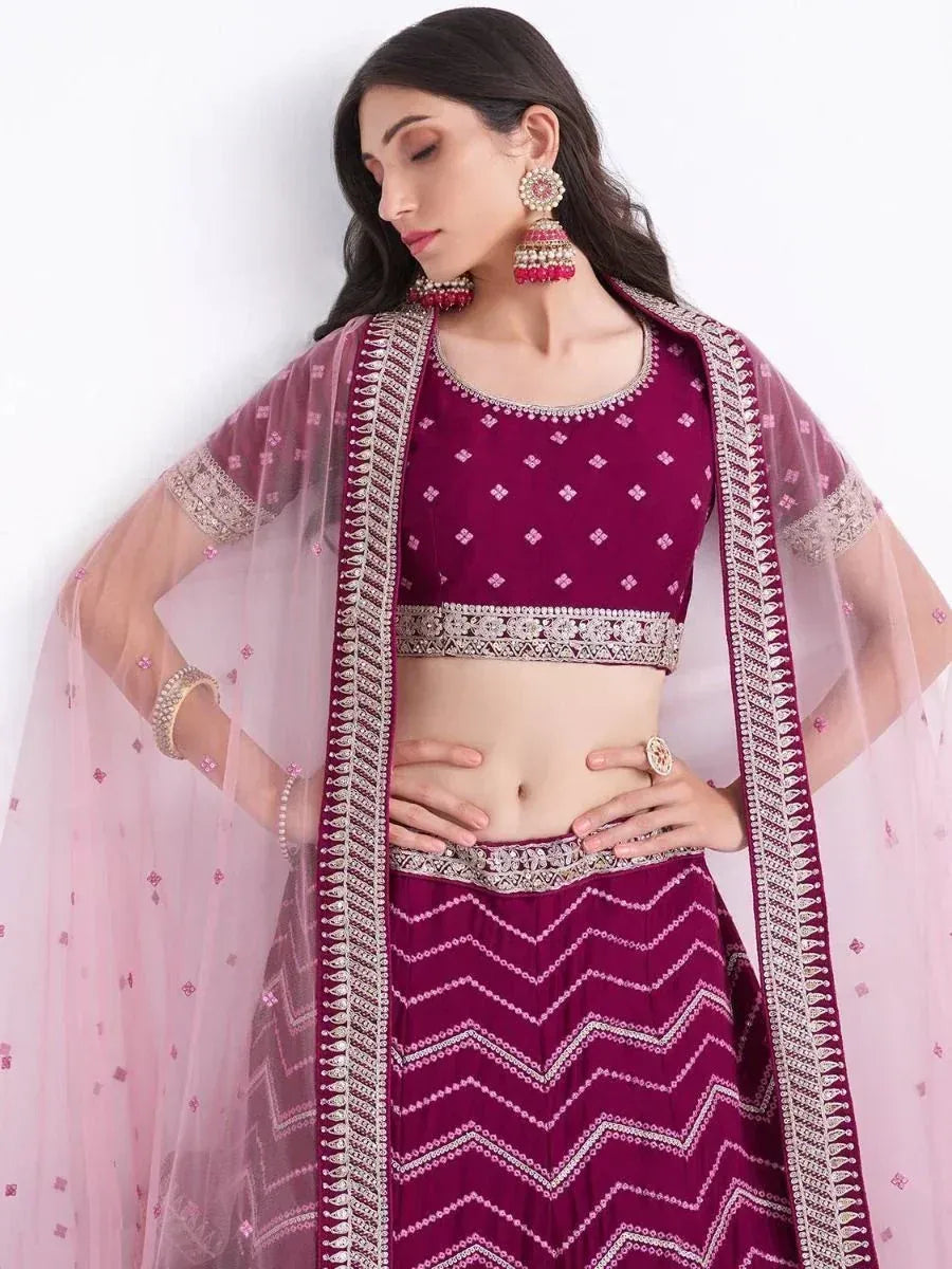 Elegant maroon lehenga choli with silver embroidery and sheer pink dupatta, perfect for Indian ethnic occasions.
