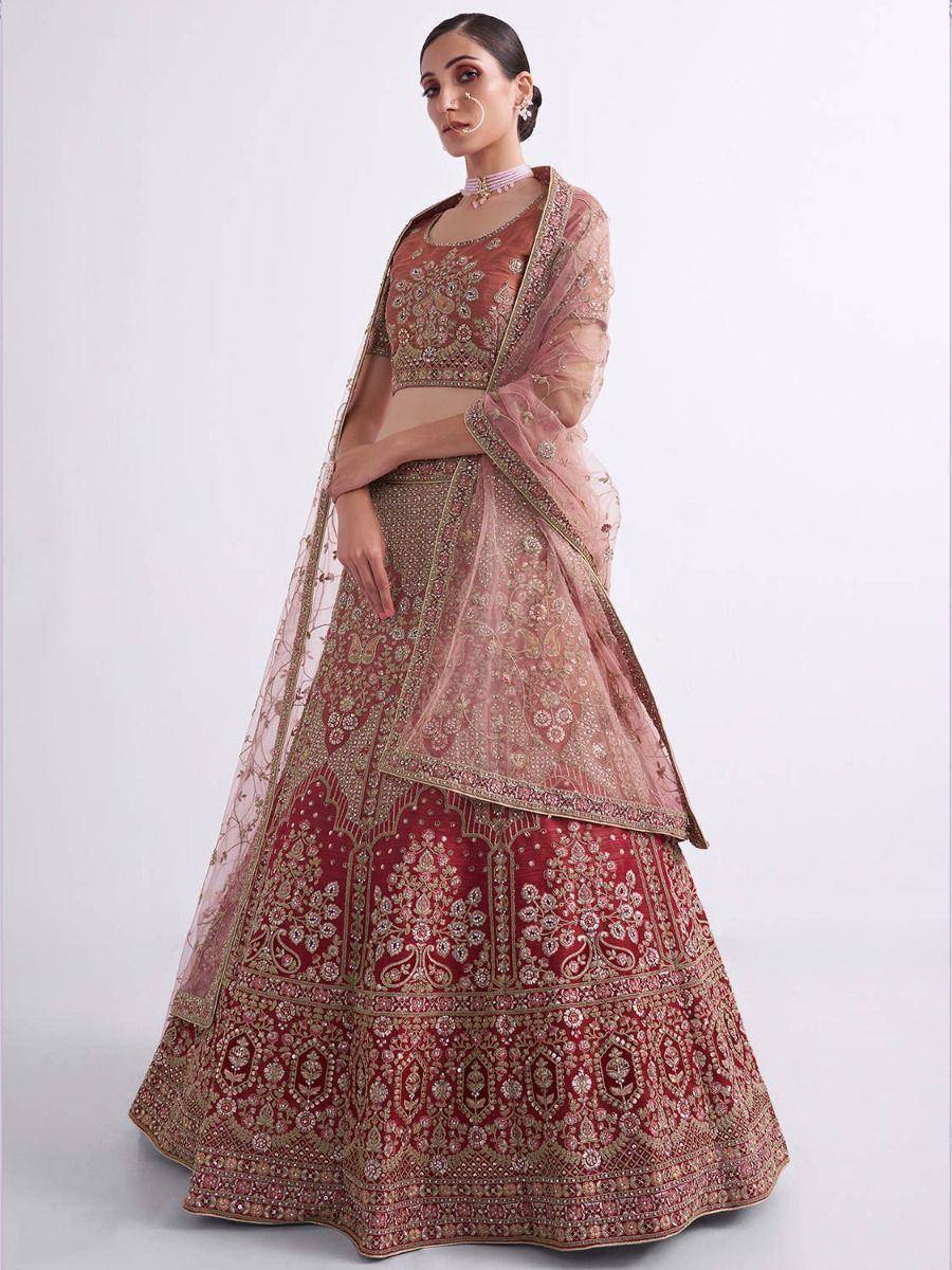 Elegant maroon lehenga choli with gold embroidery and sheer dupatta, perfect for Indian weddings and festive occasions.