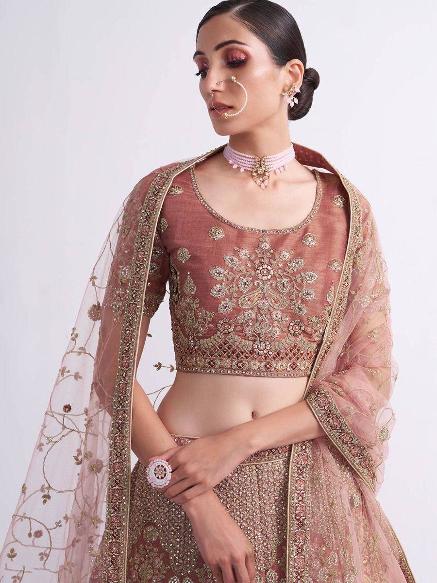Pink embroidered lehenga choli with gold detailing and sheer dupatta, perfect for Indian weddings and festive occasions.