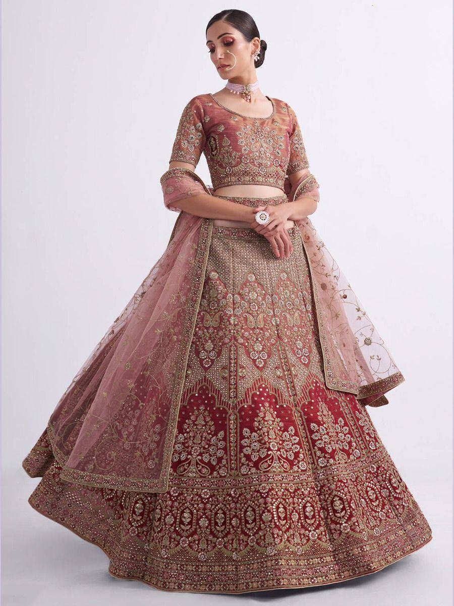 Elegant maroon and gold embroidered lehenga choli with sheer dupatta, perfect for Indian weddings and festive occasions.