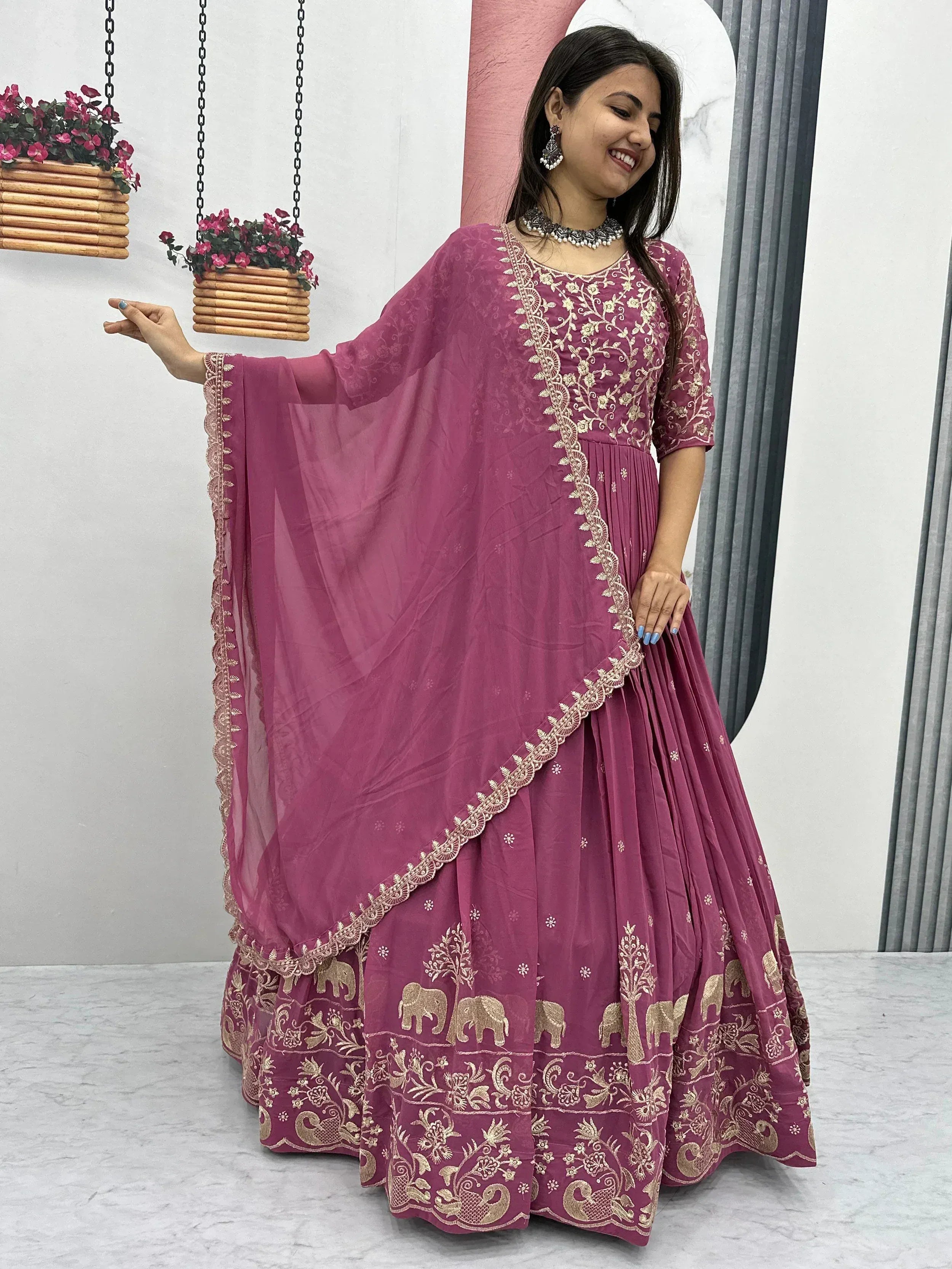 Pink embroidered Indian anarkali with gold elephant motifs and dupatta, perfect for ethnic occasions