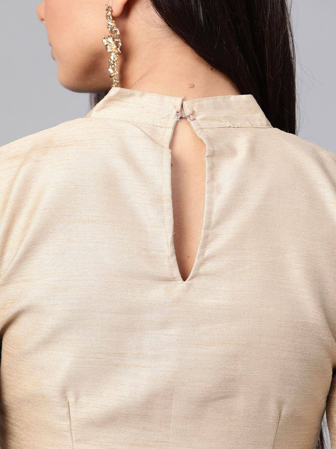 Beige ethnic top with back keyhole detail and gold earrings, perfect for Indian wear