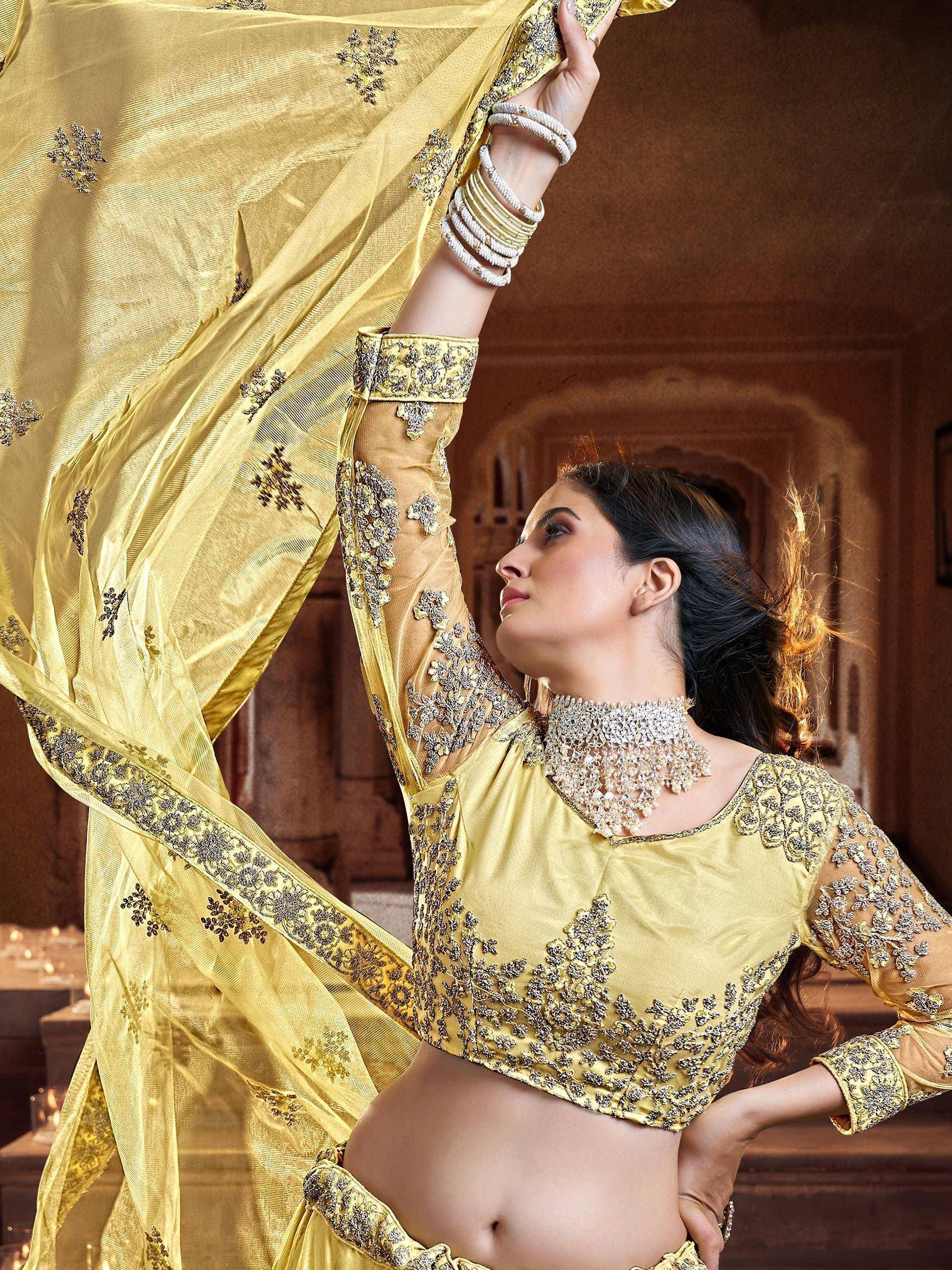 Elegant yellow designer lehenga choli with intricate embroidery and embellished dupatta for festive occasions