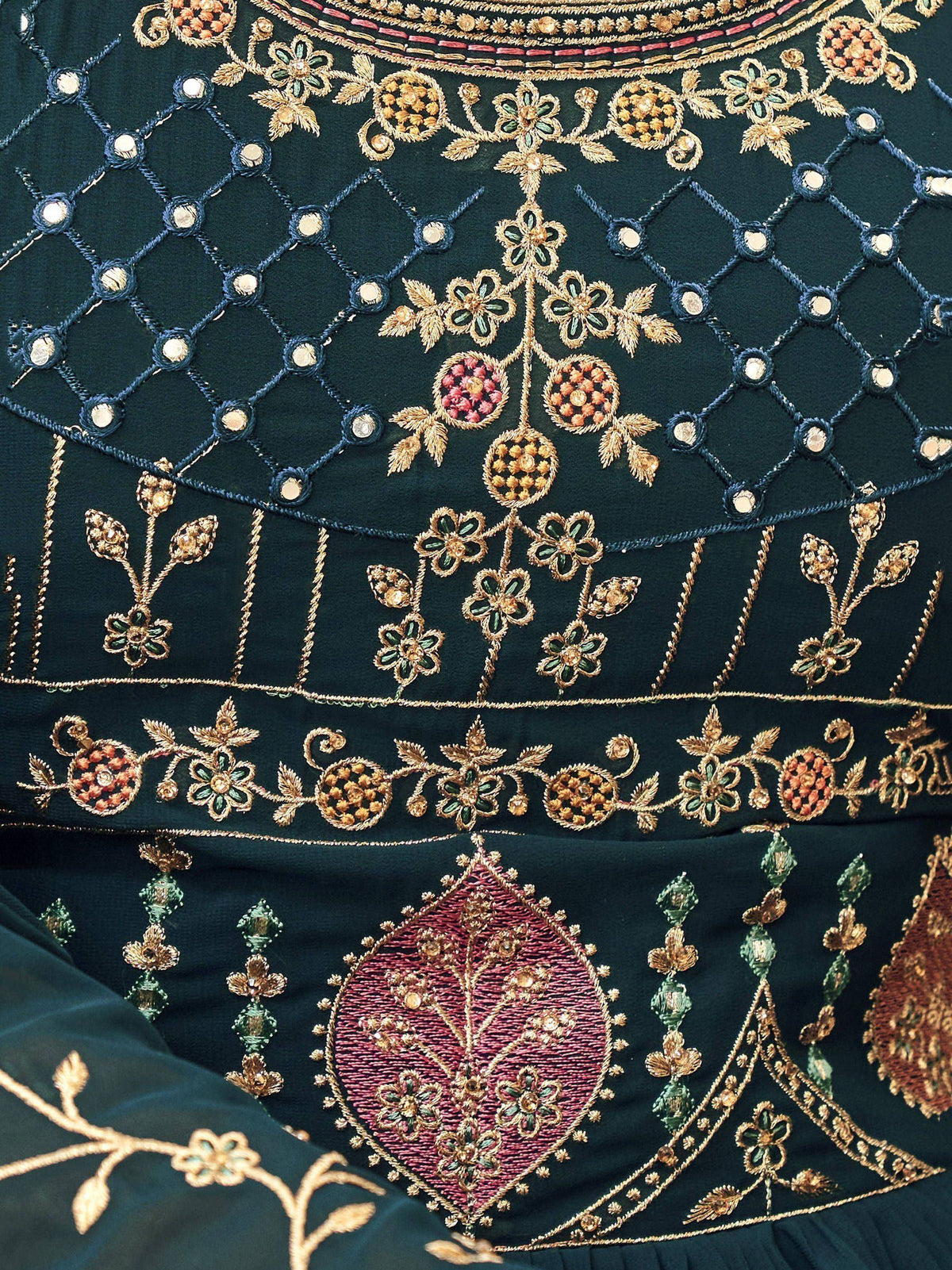 Dark green ethnic gown with gold floral embroidery, mirror work, and intricate zari detailing for festive occasions.