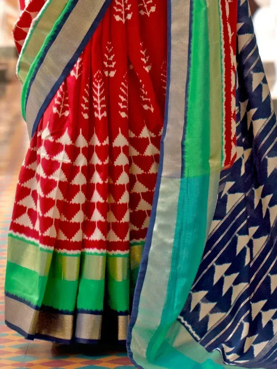 Red and green ethnic saree with geometric patterns and border designs