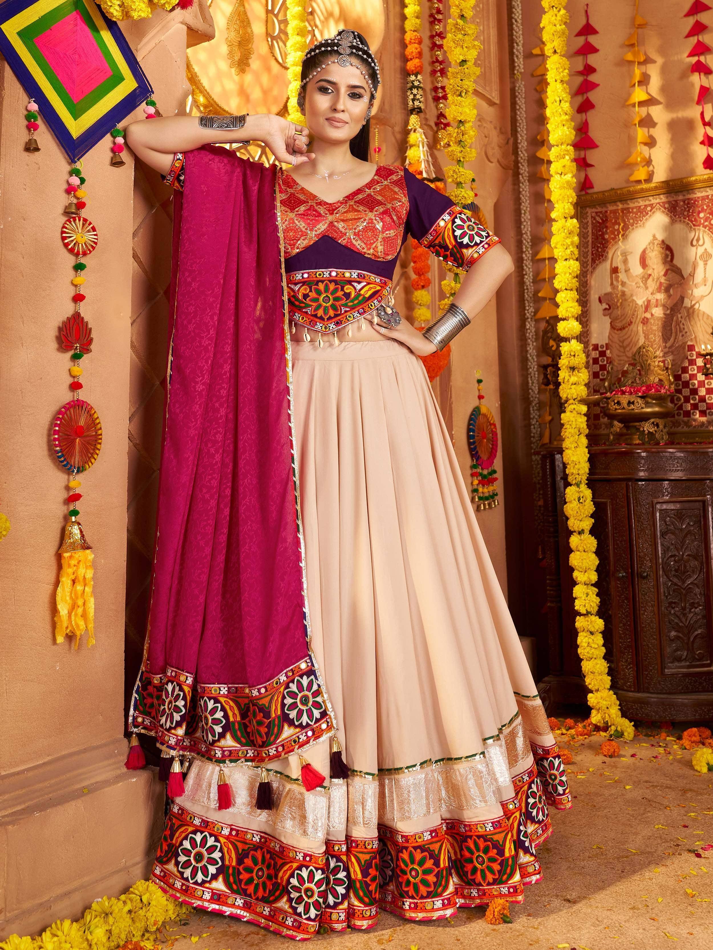Woman in vibrant Indian ethnic wear with embroidered lehenga choli and dupatta, festive decor background