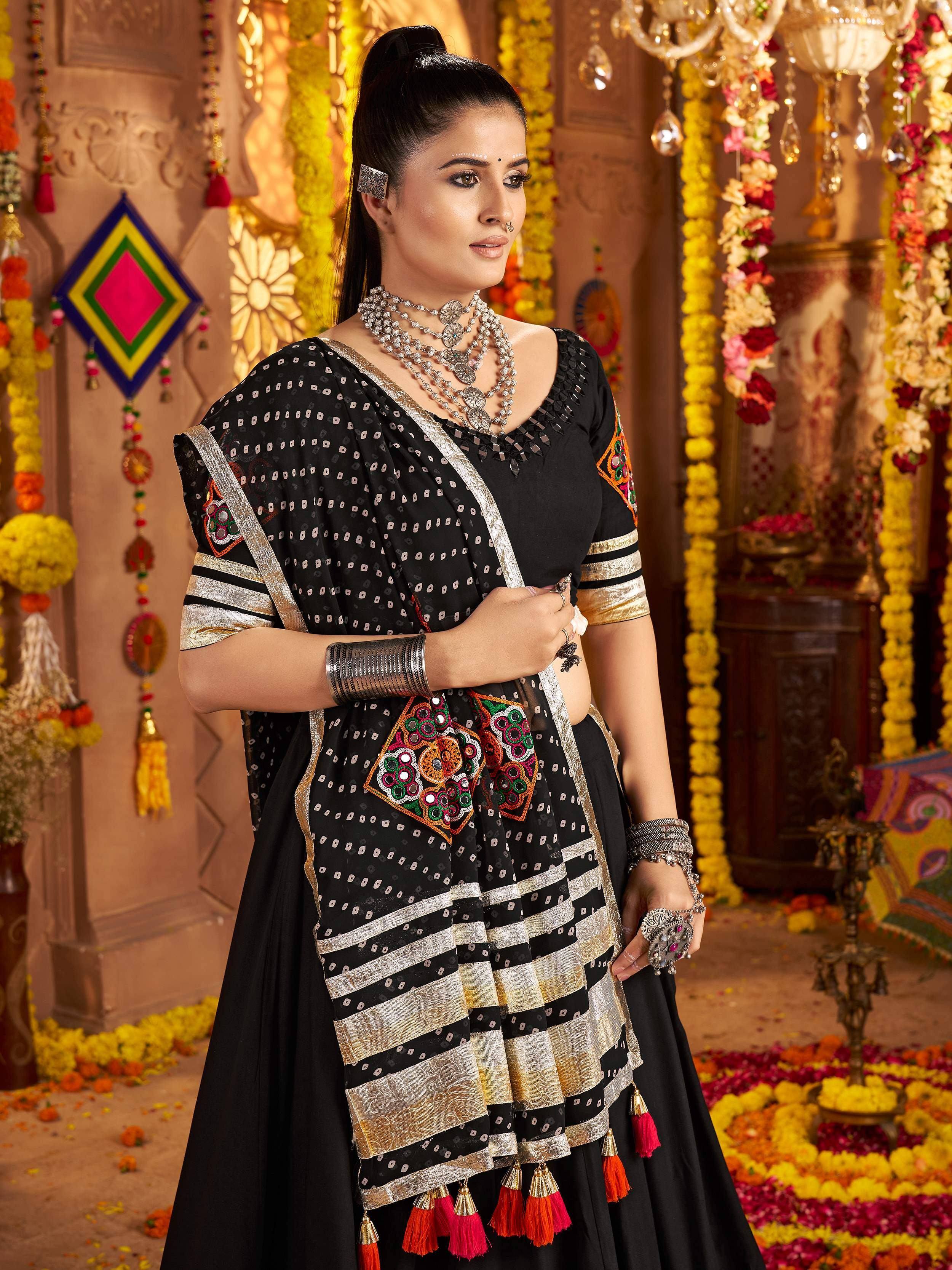Black embroidered lehenga choli with gold trim and mirror work, perfect for Indian ethnic occasions