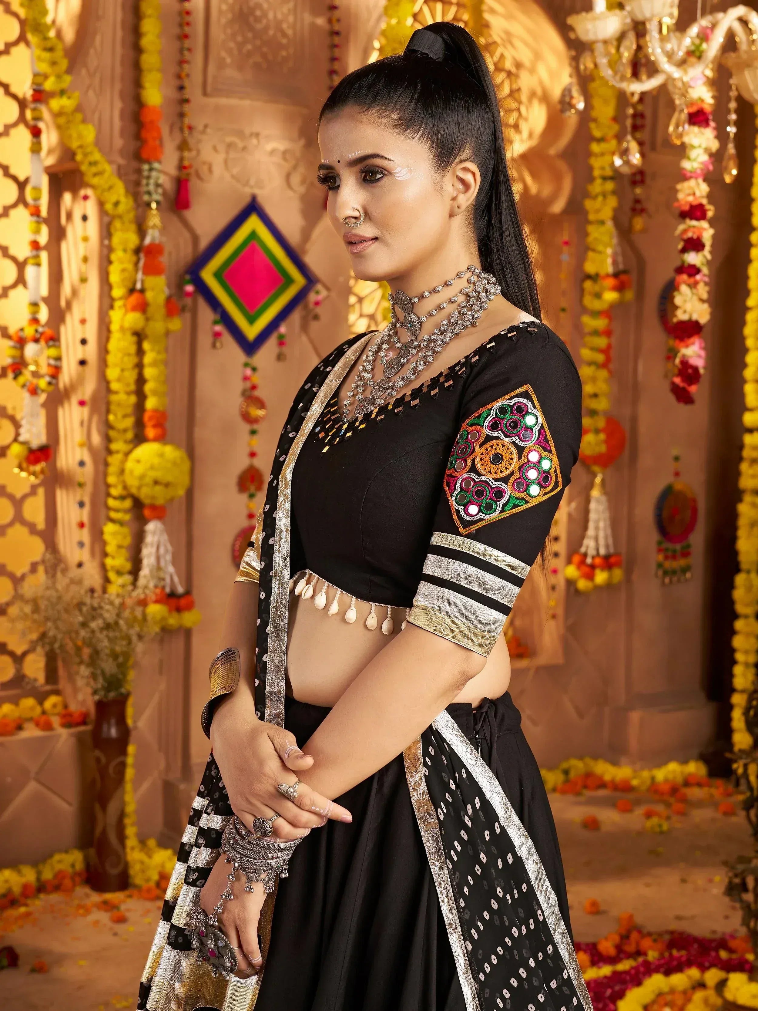 Black embroidered lehenga choli with mirror work, perfect for Indian ethnic wear and festive occasions.
